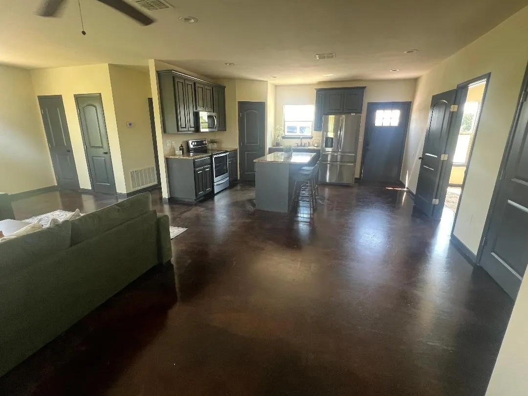 Living area with finished concrete flooring and a ceiling fan