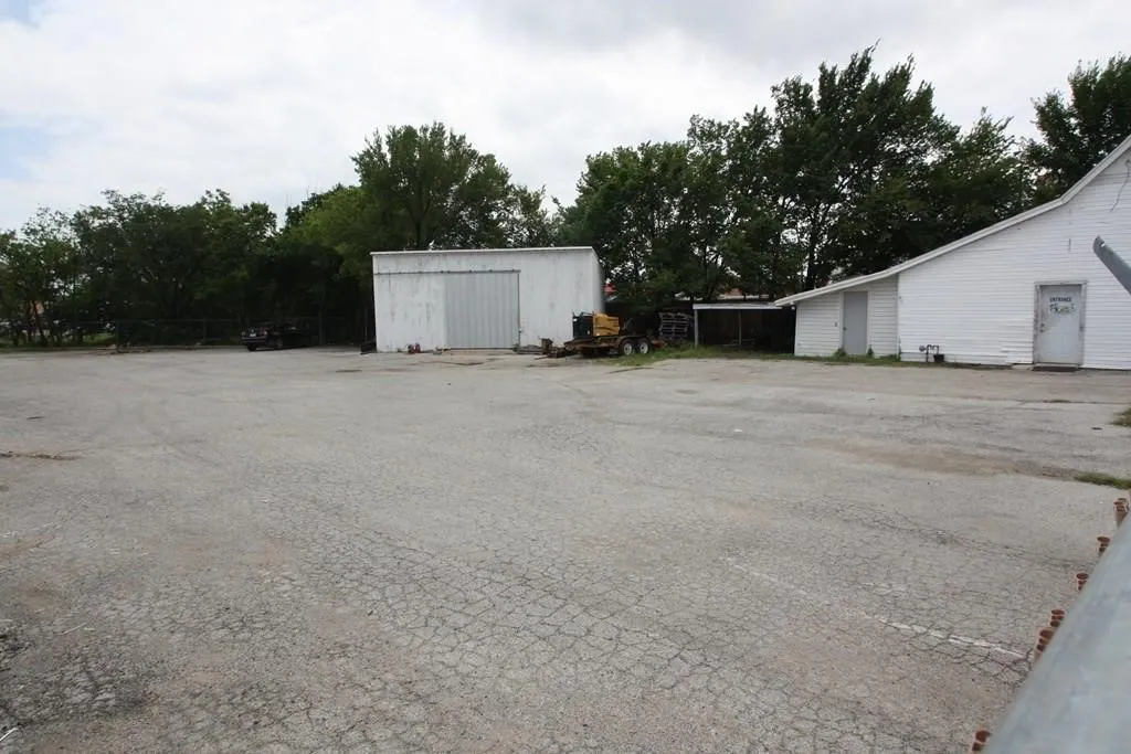 View of yard with an outbuilding and a pole building