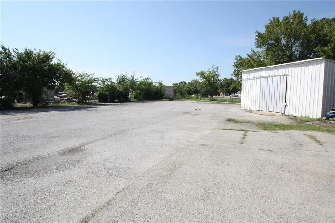 View of parking with an outbuilding