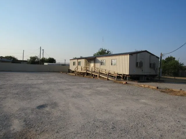 Front with large parking area.