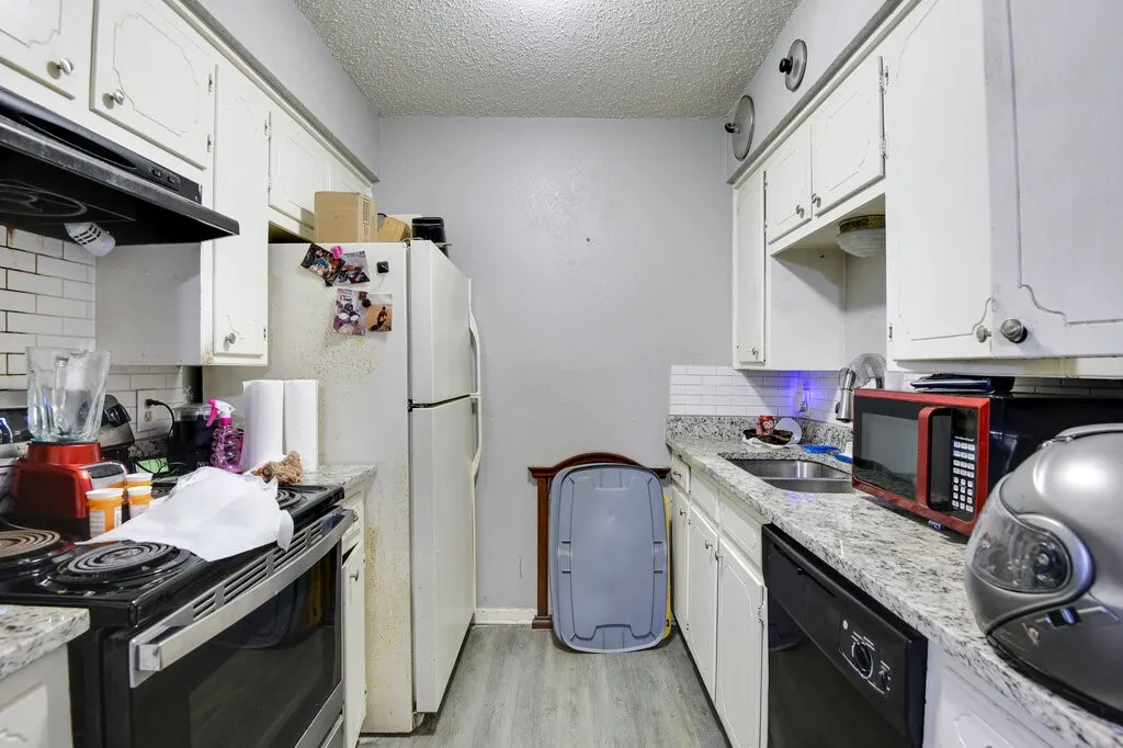Left Unit Kitchen with backsplash, electric range, white cabinets, light wood-style flooring, and a textured ceiling