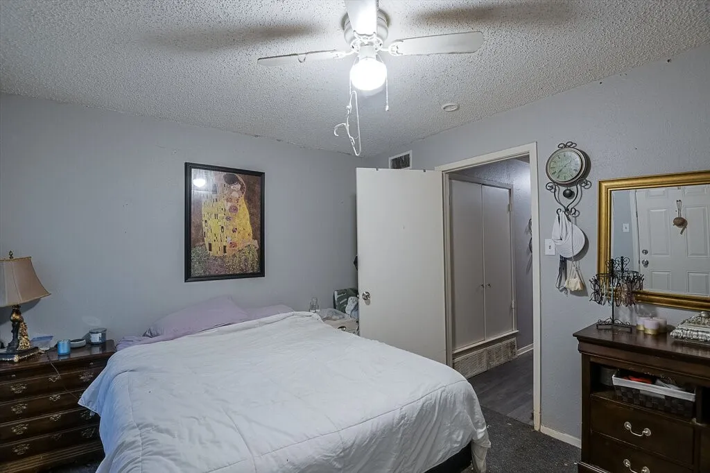 Right Unit Bedroom featuring a textured ceiling and a ceiling fan