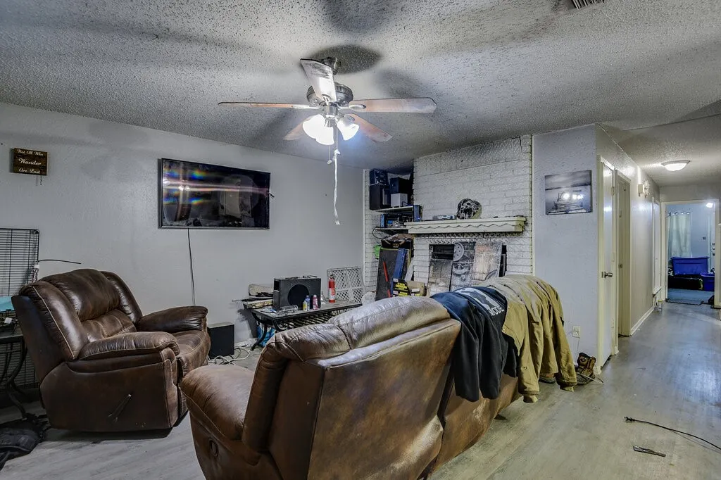 Left Unit Living room featuring wood finished floors, a textured ceiling, and ceiling fan