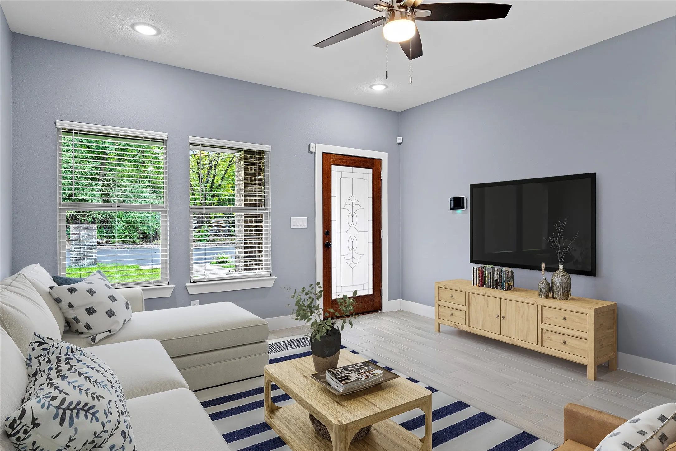 Living room featuring wood finished floors, recessed lighting, and a ceiling fan