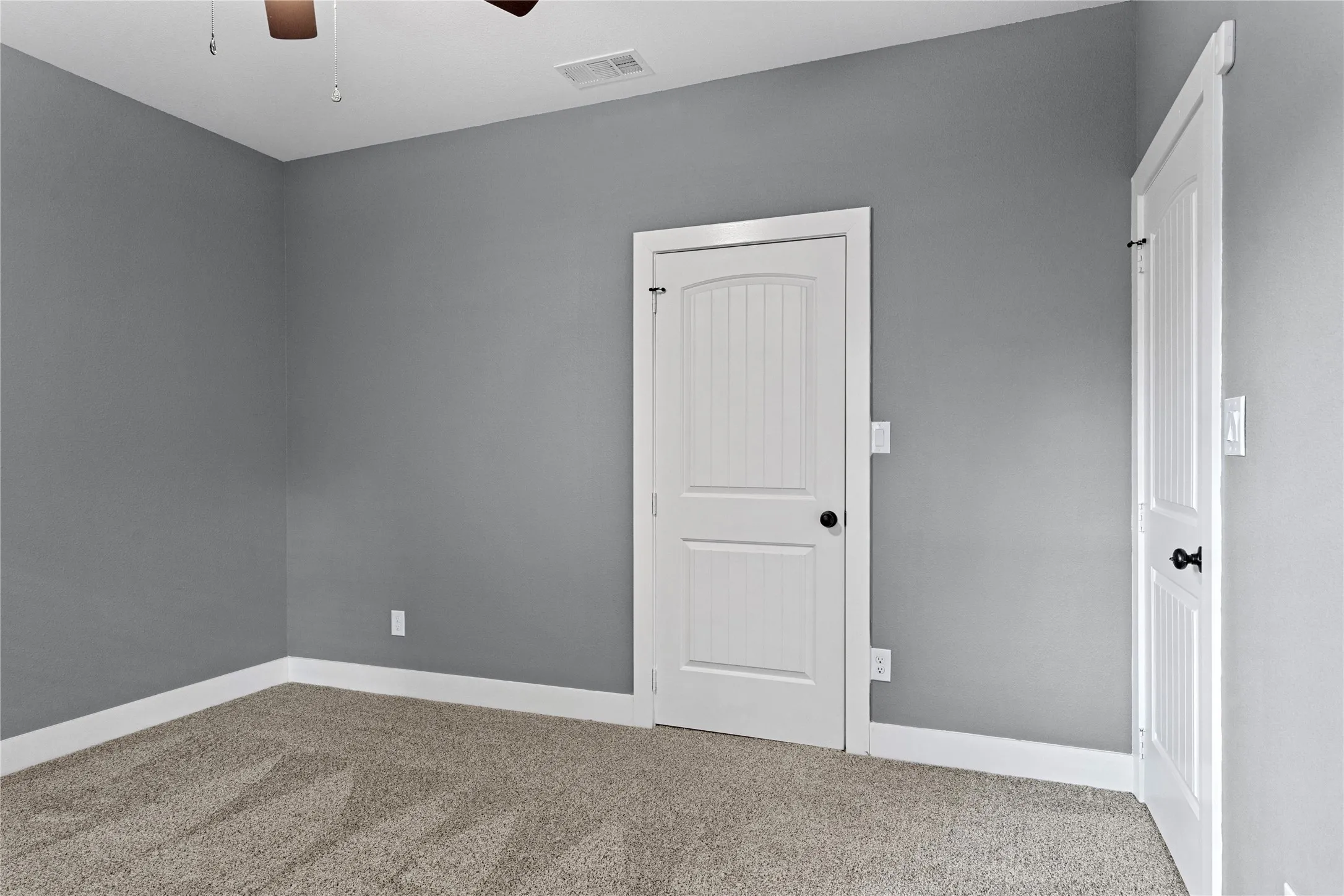 Unfurnished bedroom with carpet, a ceiling fan, and a closet