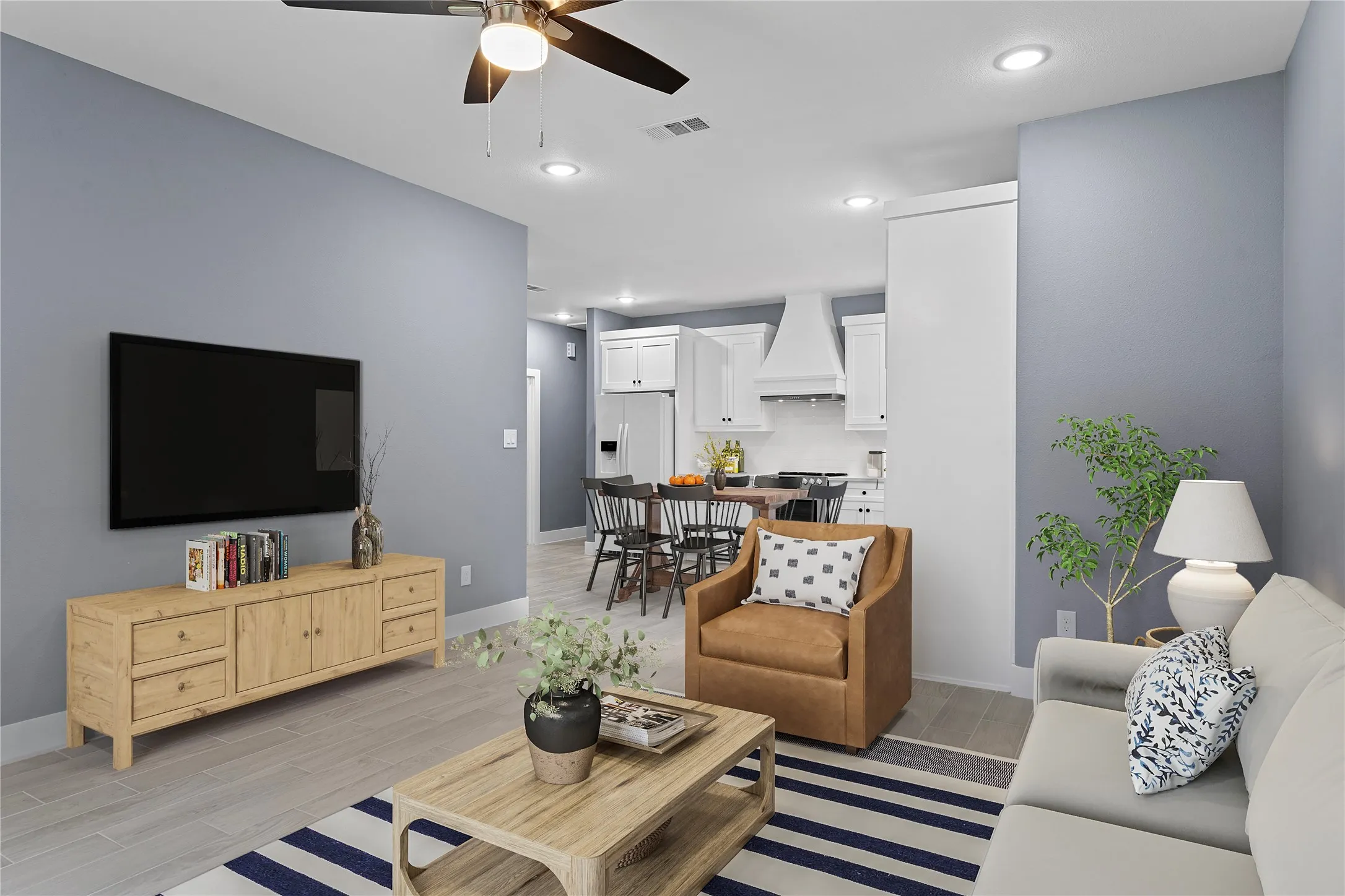 Living area featuring wood tiled floors, recessed lighting, and ceiling fan
