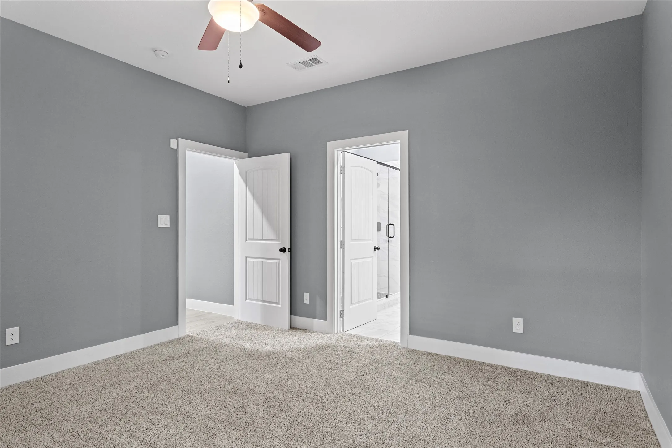 Unfurnished bedroom featuring light colored carpet and a ceiling fan