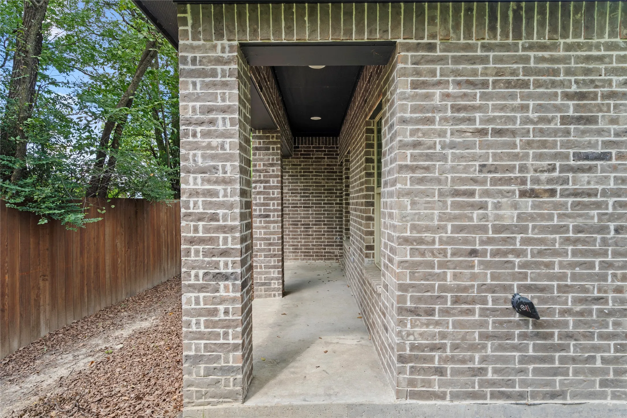 Property entrance featuring brick siding