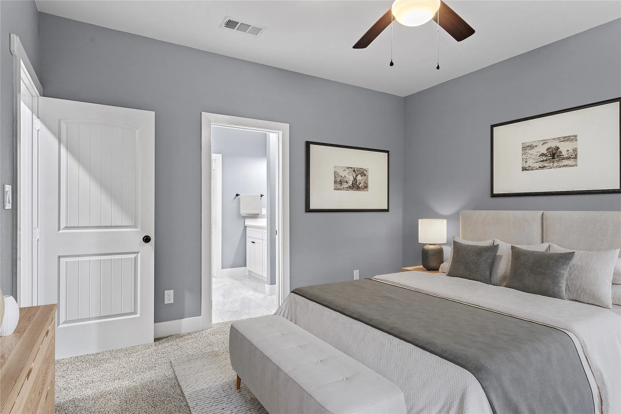 Bedroom with light carpet, connected bathroom, and ceiling fan