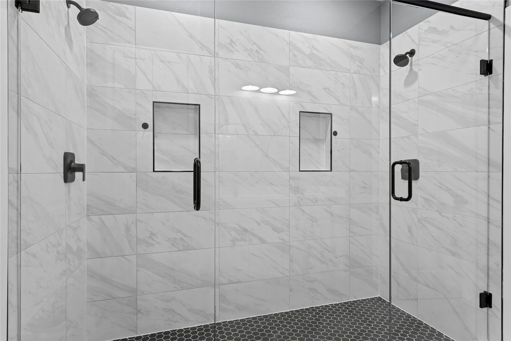 Full bathroom featuring a shower stall