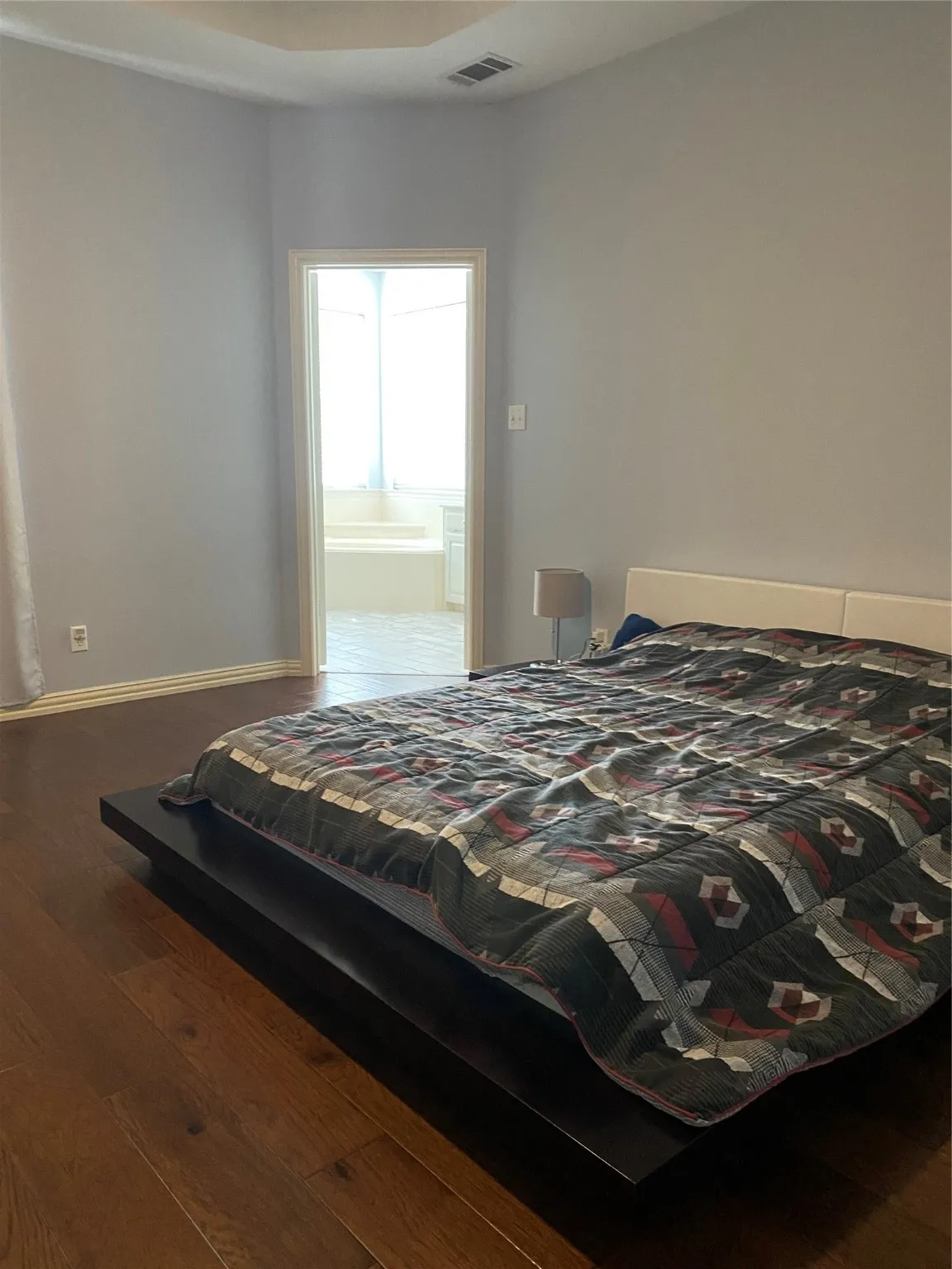 Bedroom featuring hardwood / wood-style floors and baseboards