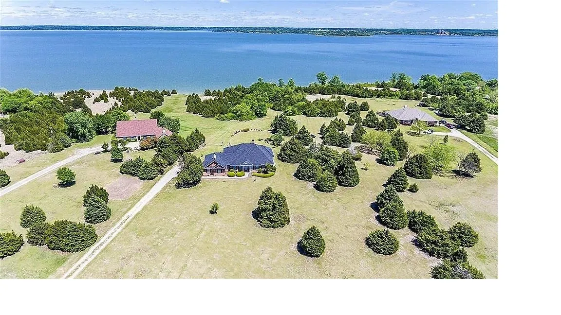 Aerial view of property and surrounding area with a large body of water