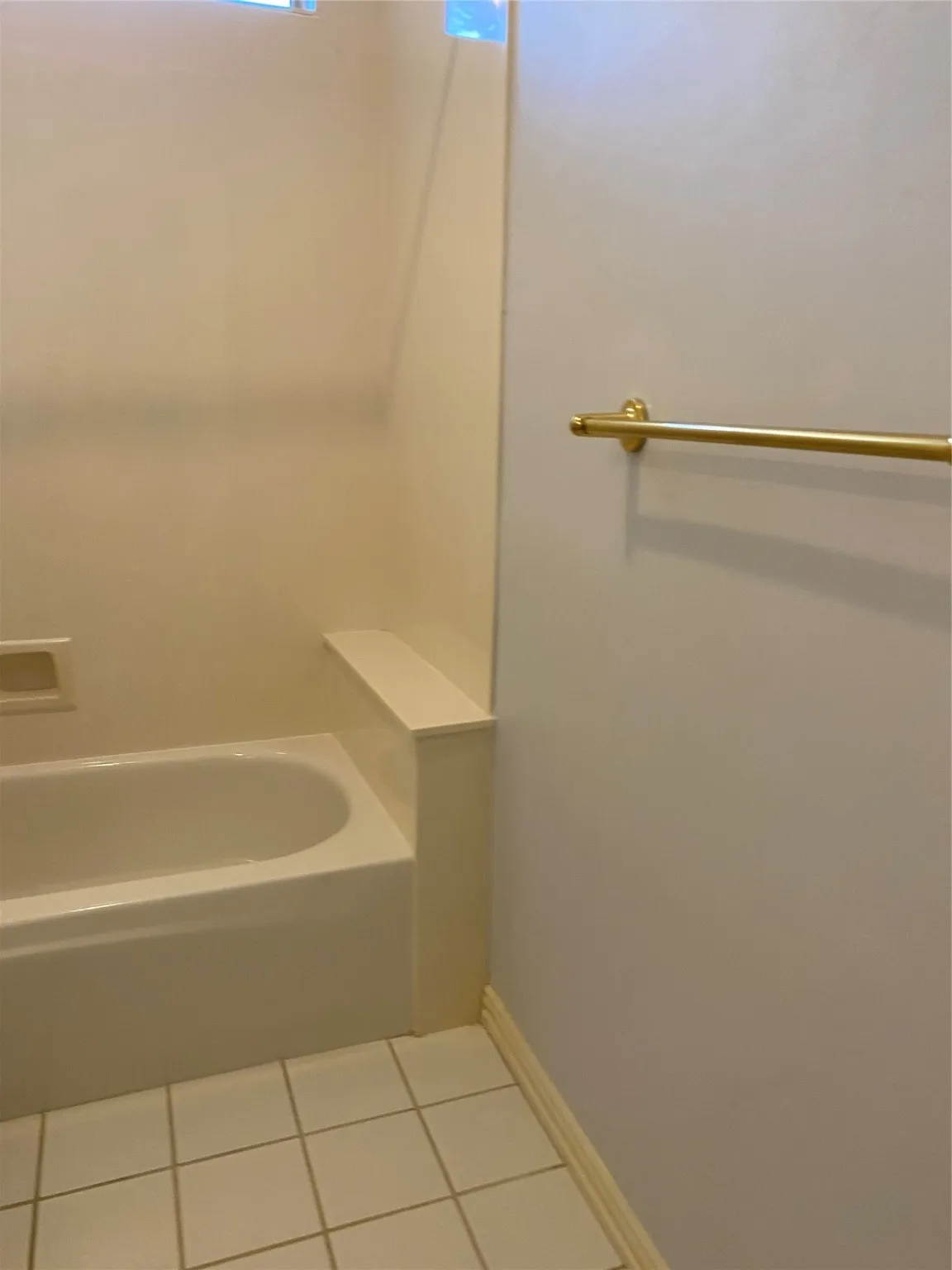 Bathroom with tile patterned flooring and shower / bath combination