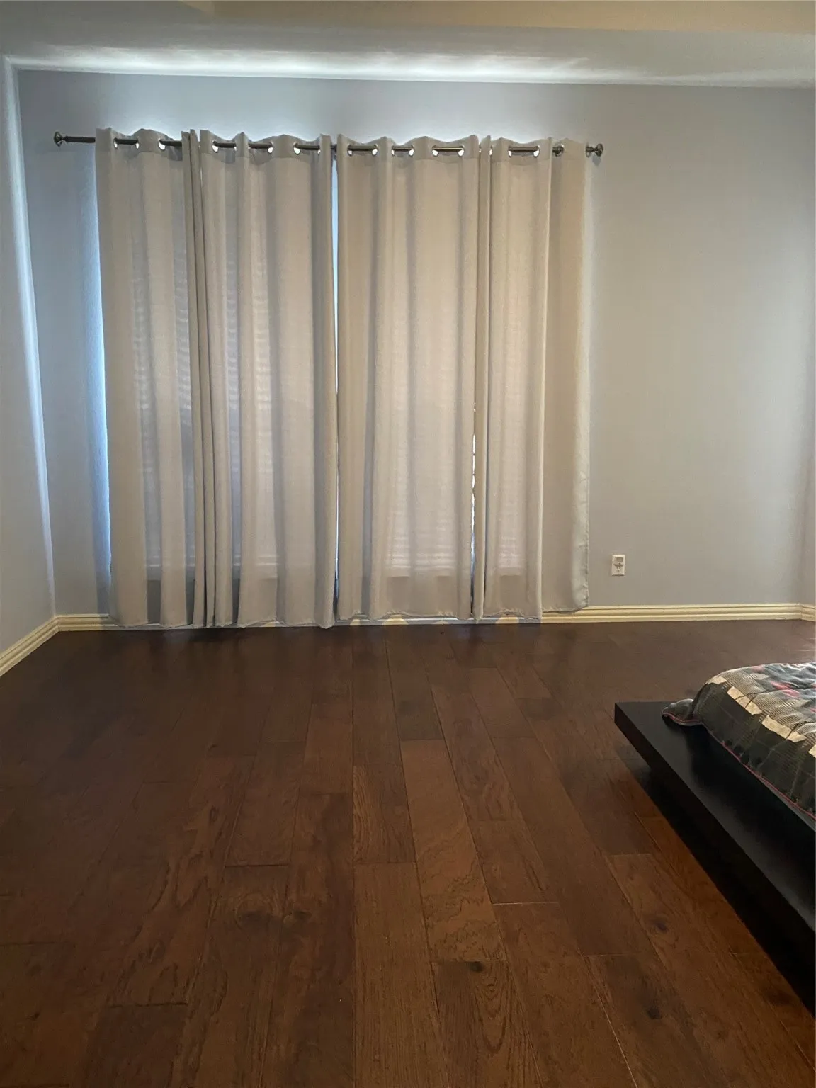Bedroom with dark wood-type flooring