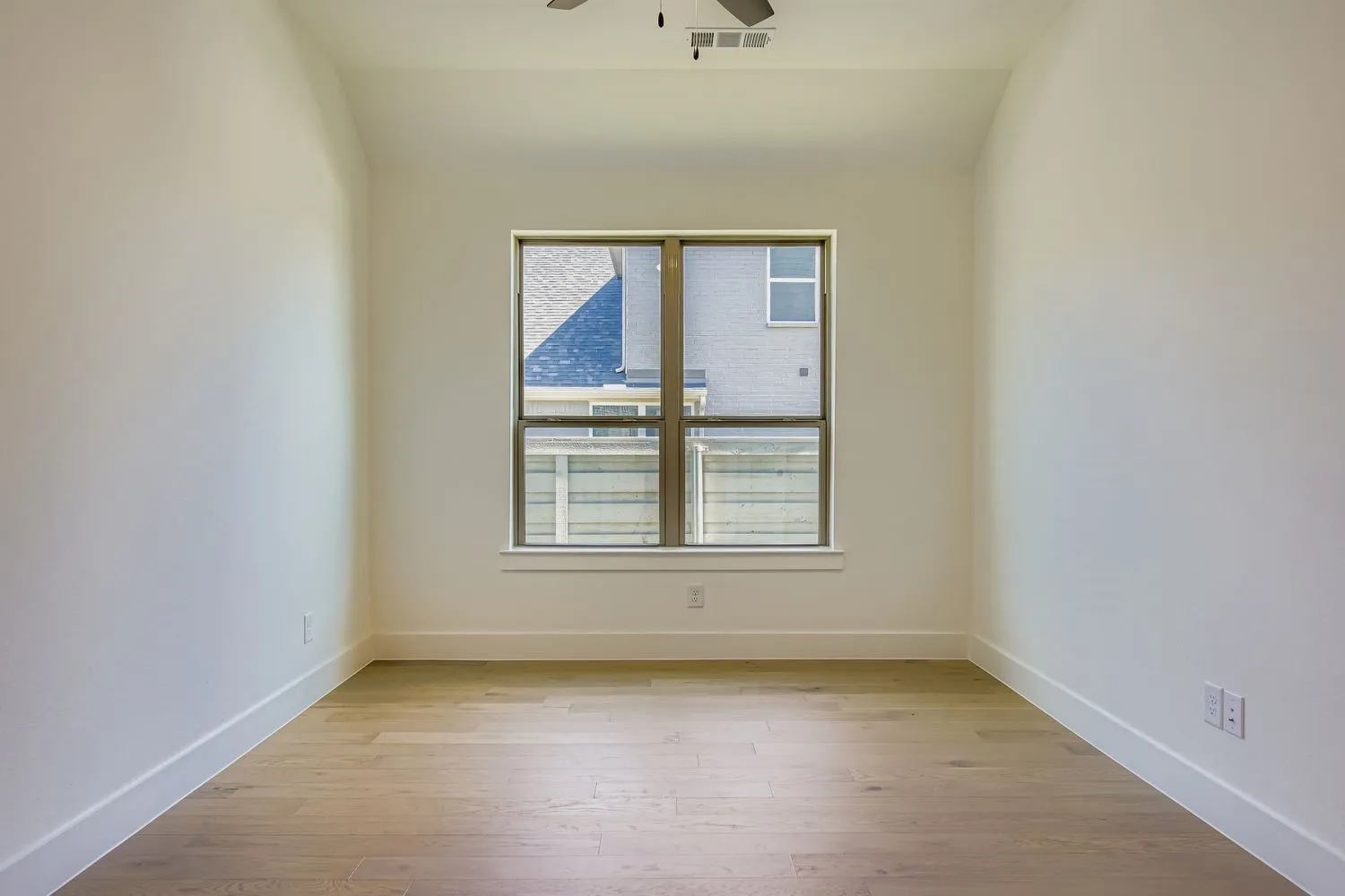 Spare room featuring light wood-style flooring and ceiling fan
