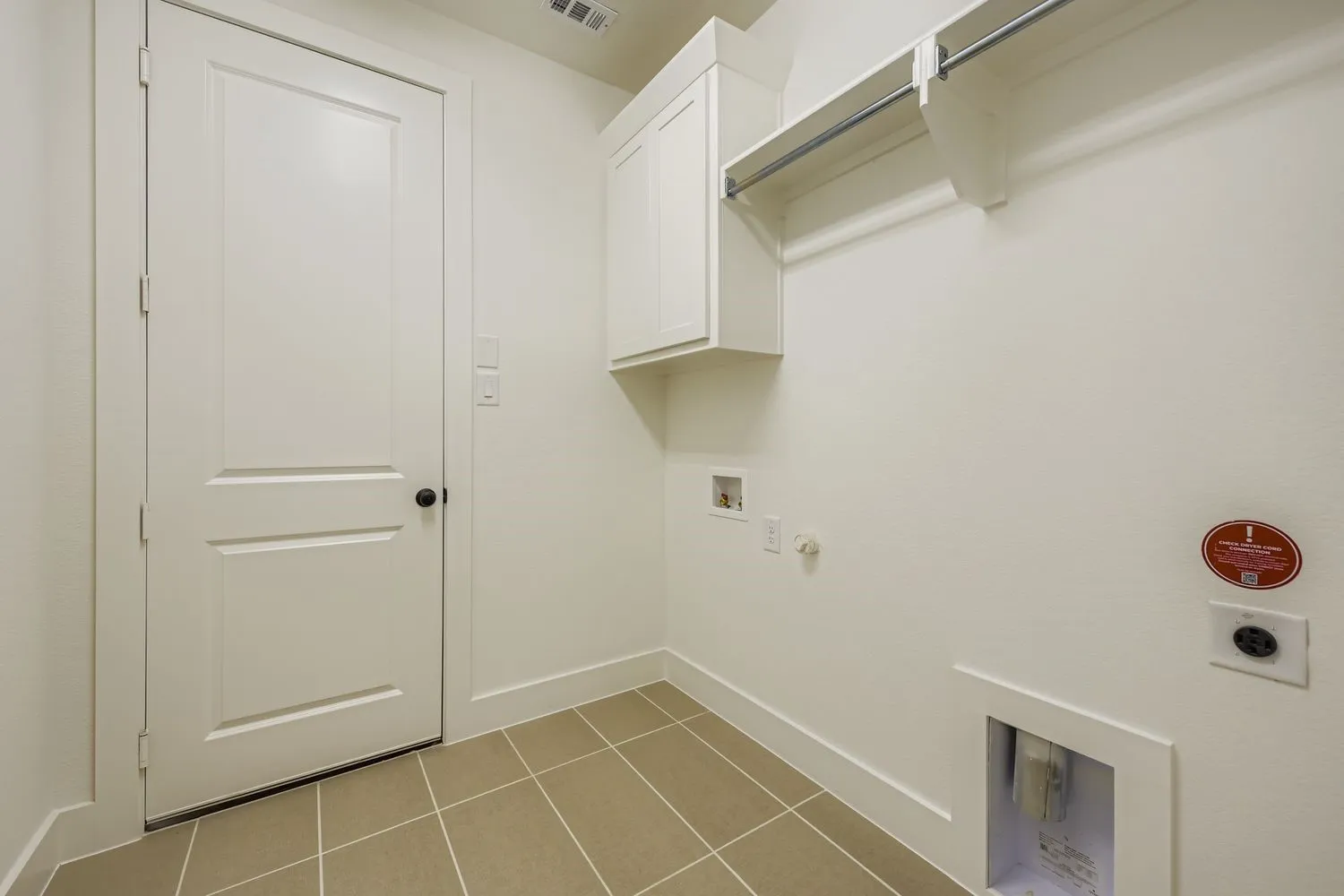 Washroom with hookup for a gas dryer, light tile patterned floors, hookup for a washing machine, cabinet space, and electric dryer hookup