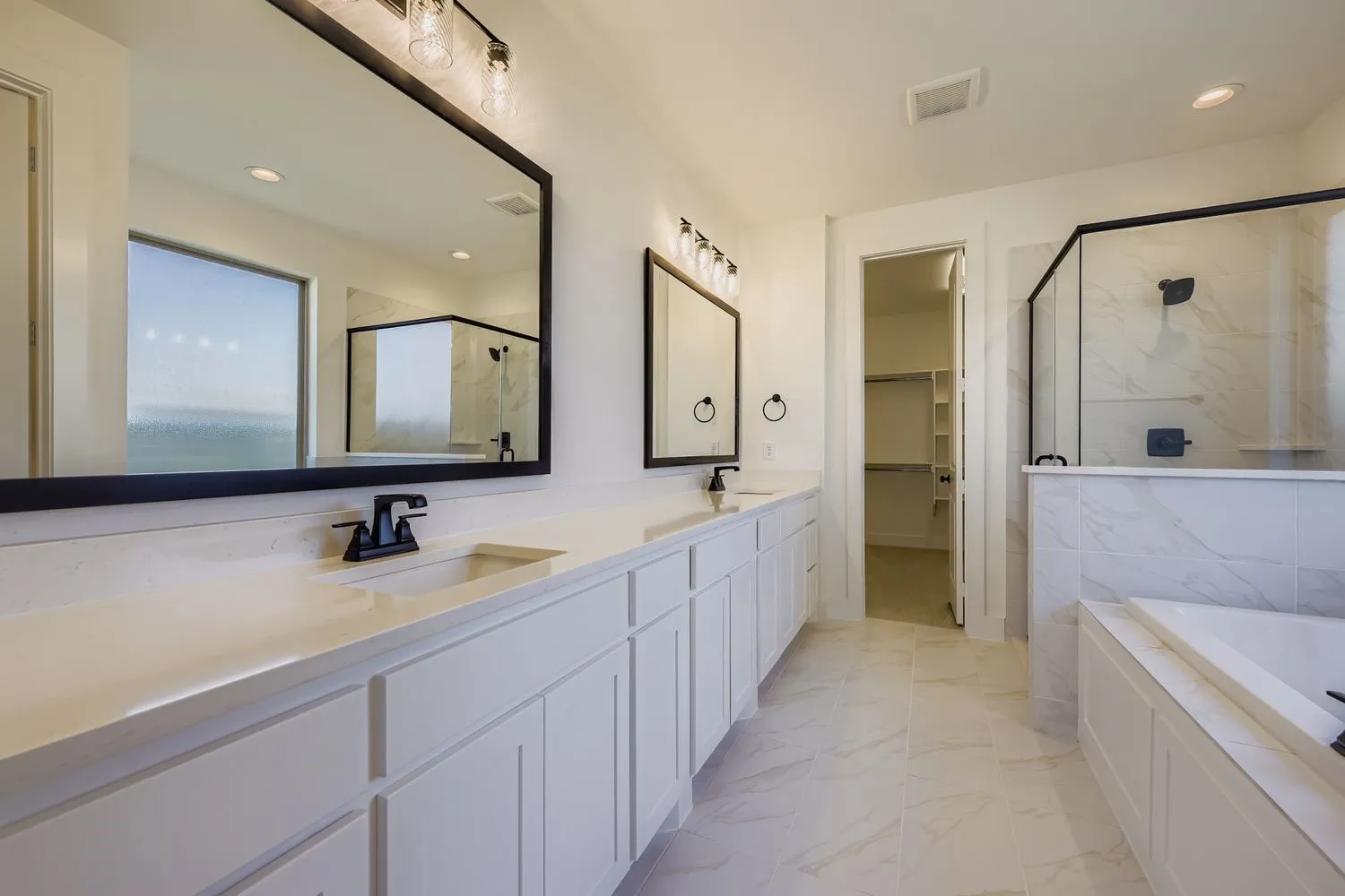 Full bathroom with a marble finish shower, a bath, double vanity, a spacious closet, and recessed lighting