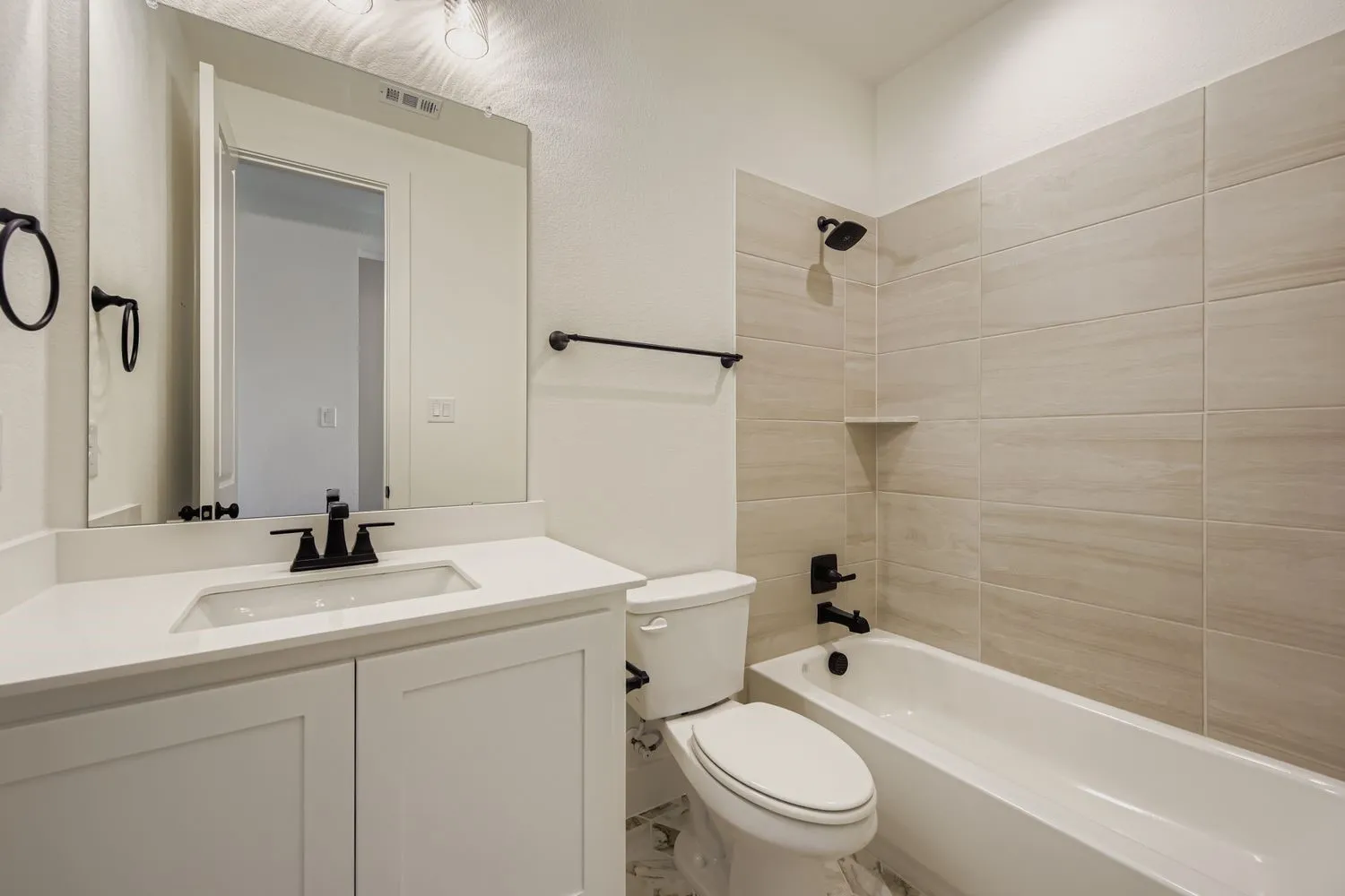 Bathroom featuring washtub / shower combination and vanity