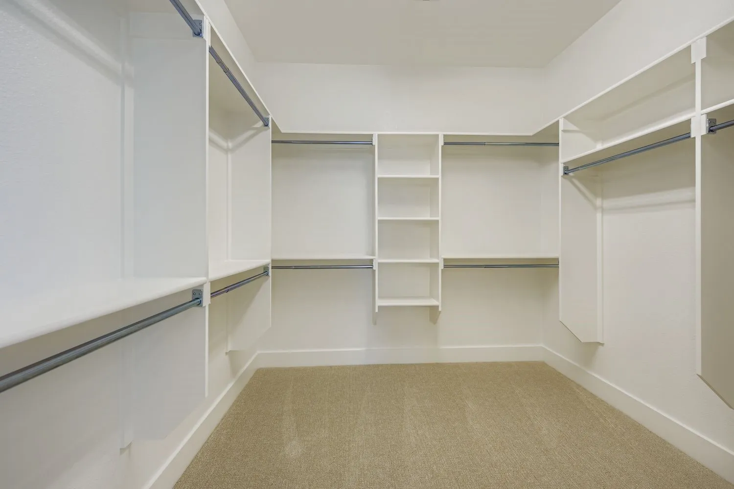 Walk in closet featuring light colored carpet
