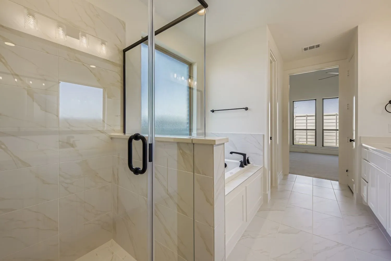 Full bathroom with a bath, a marble finish shower, vanity, and light marble finish floors