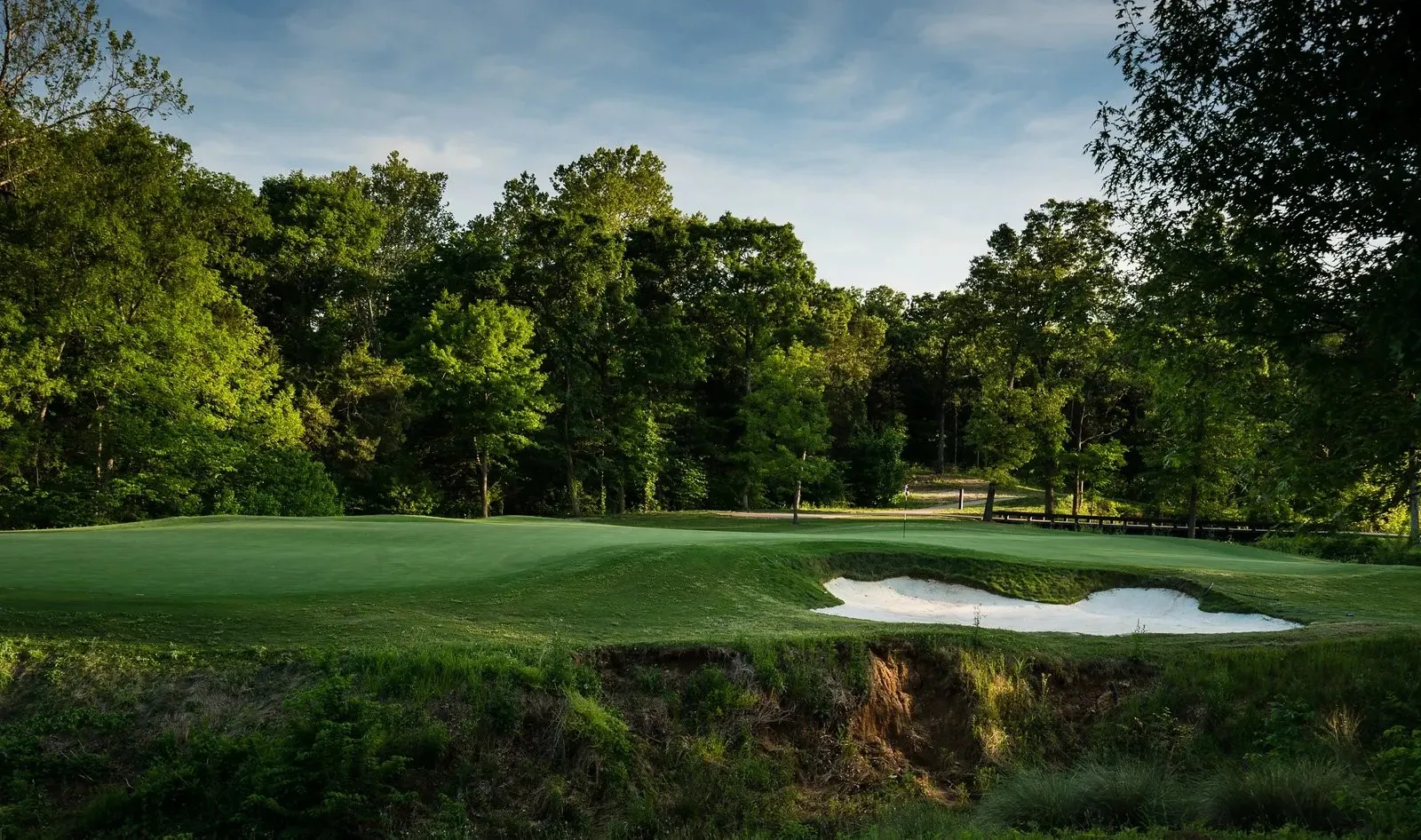 View of community featuring golf course view and a yard