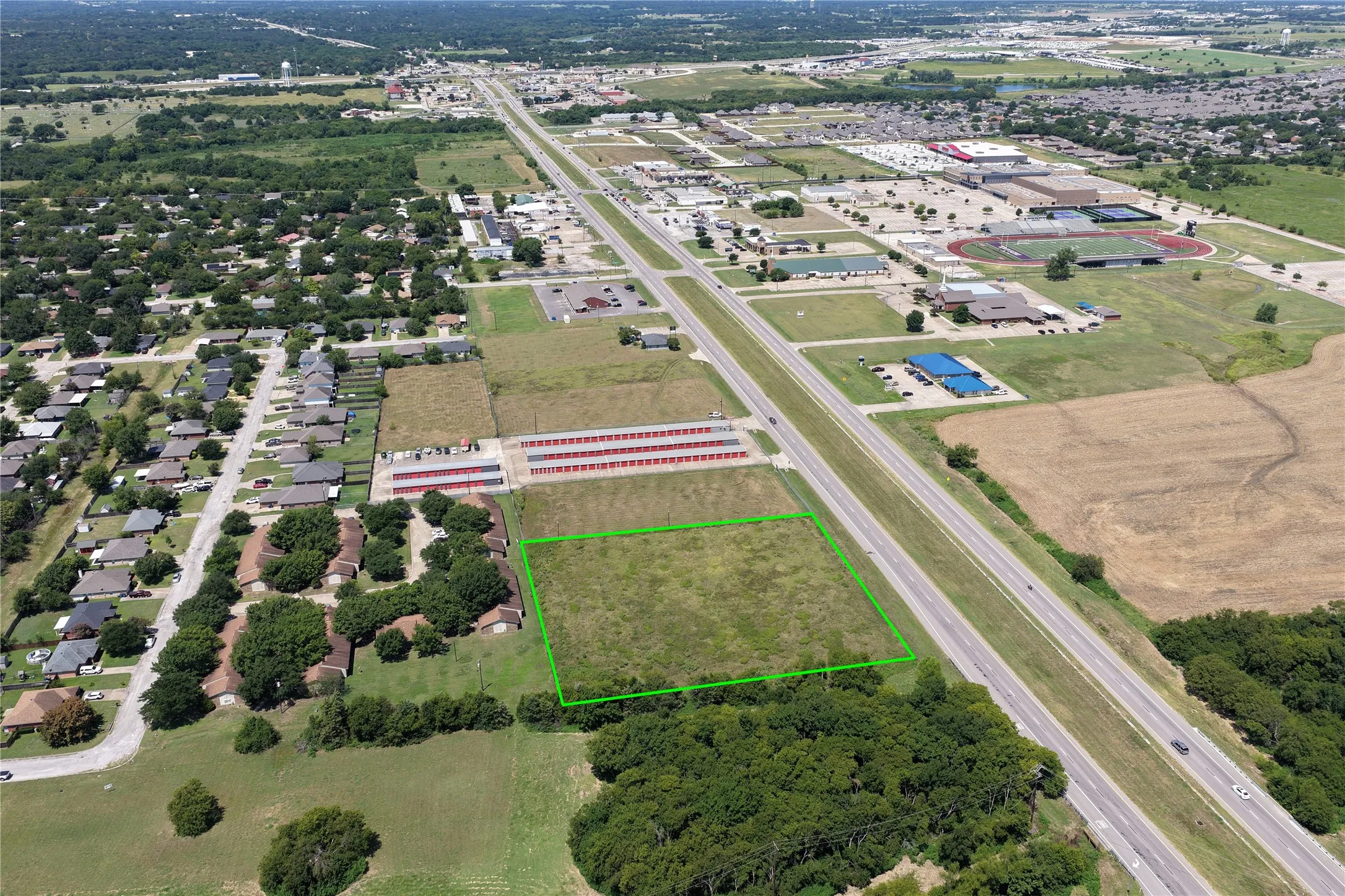 Aerial view of property and surrounding area featuring property parcel outlined