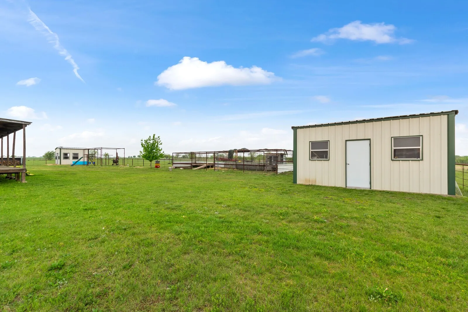 View of yard with a shed and a playground