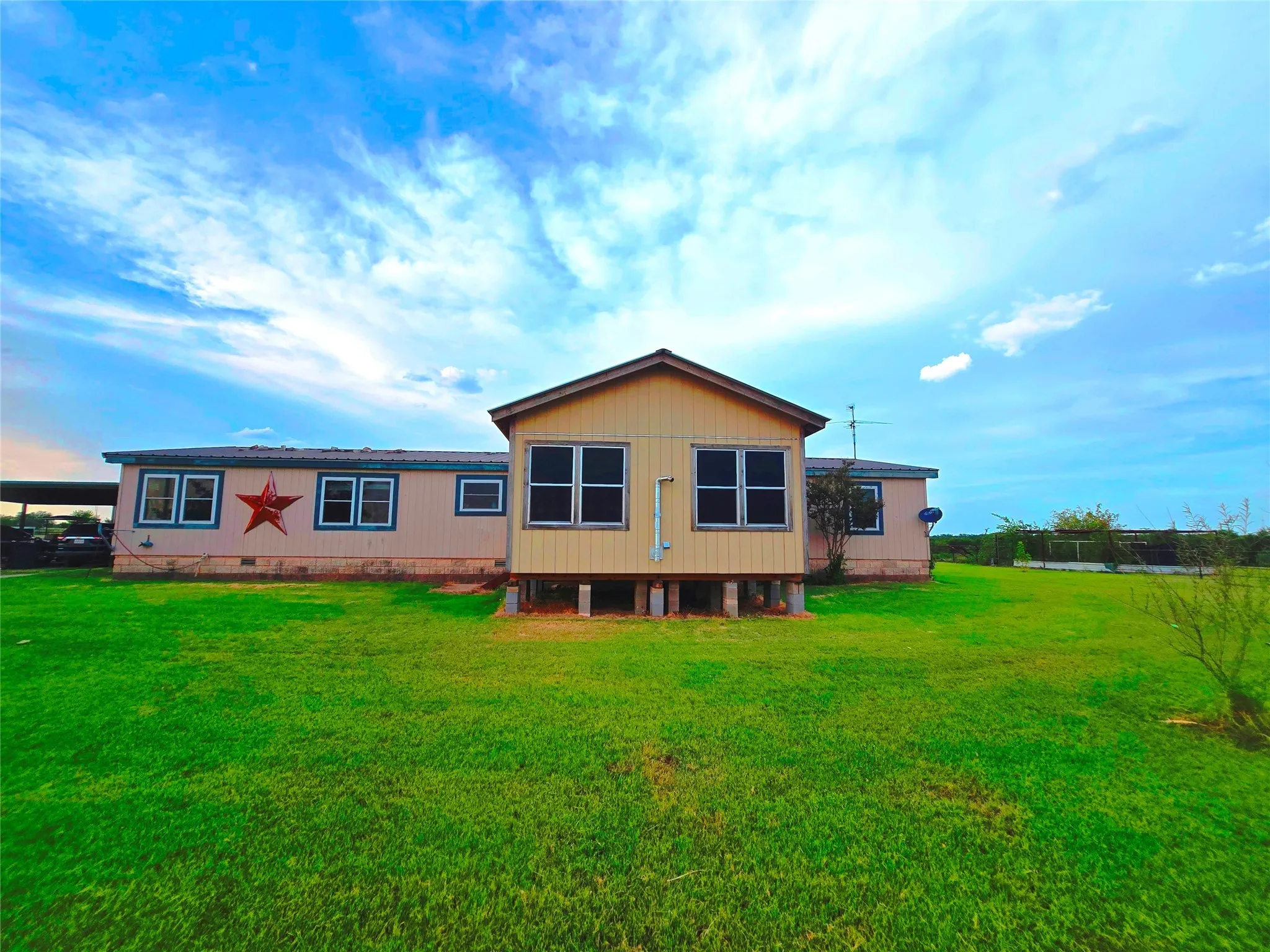 View of front of home with a front lawn and crawl space