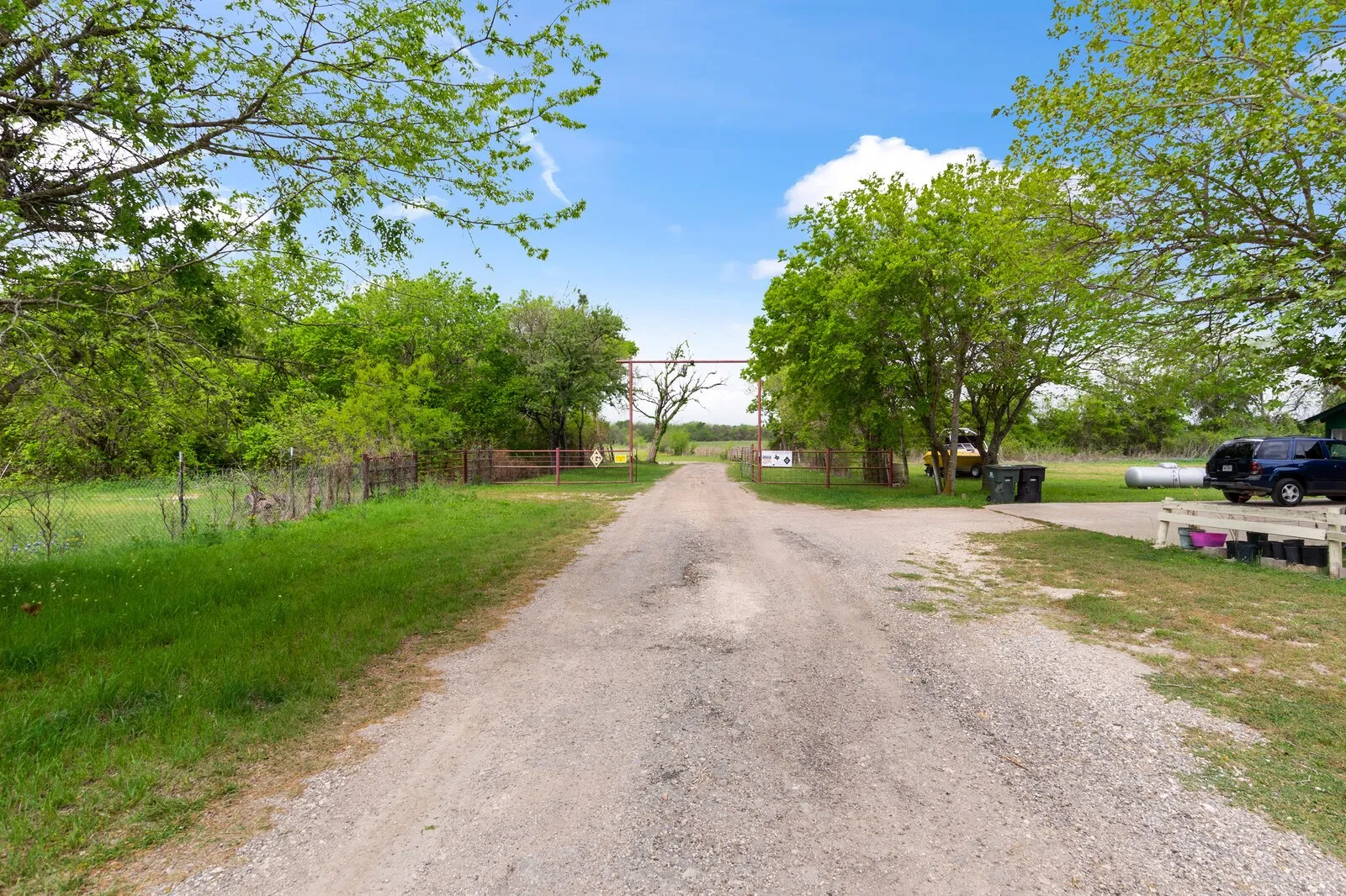 View of dirt / gravel road featuring a view of rural / pastoral area