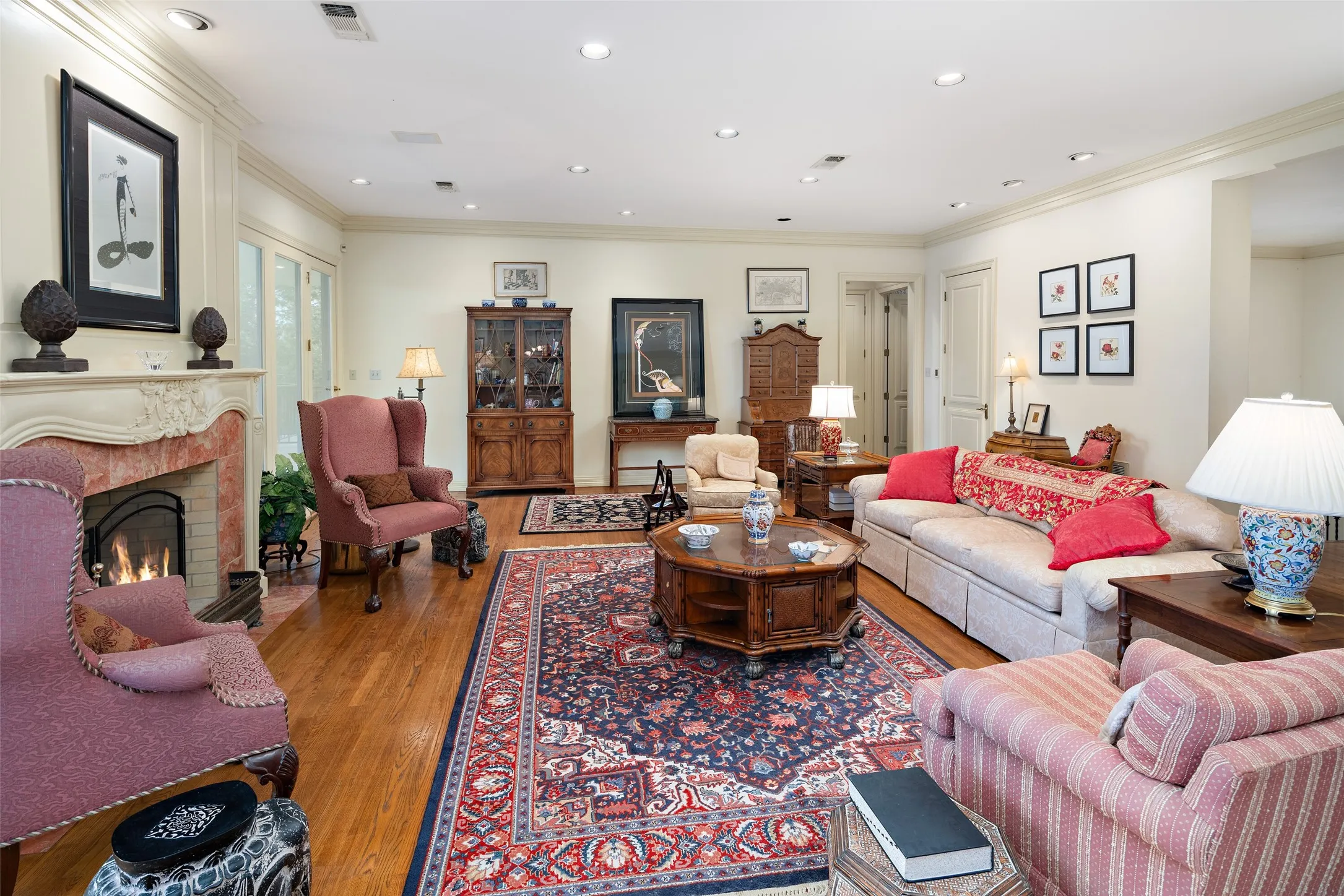 Living area with crown molding, wood floors, recessed lighting, a fireplace and fireplace located on the third level.