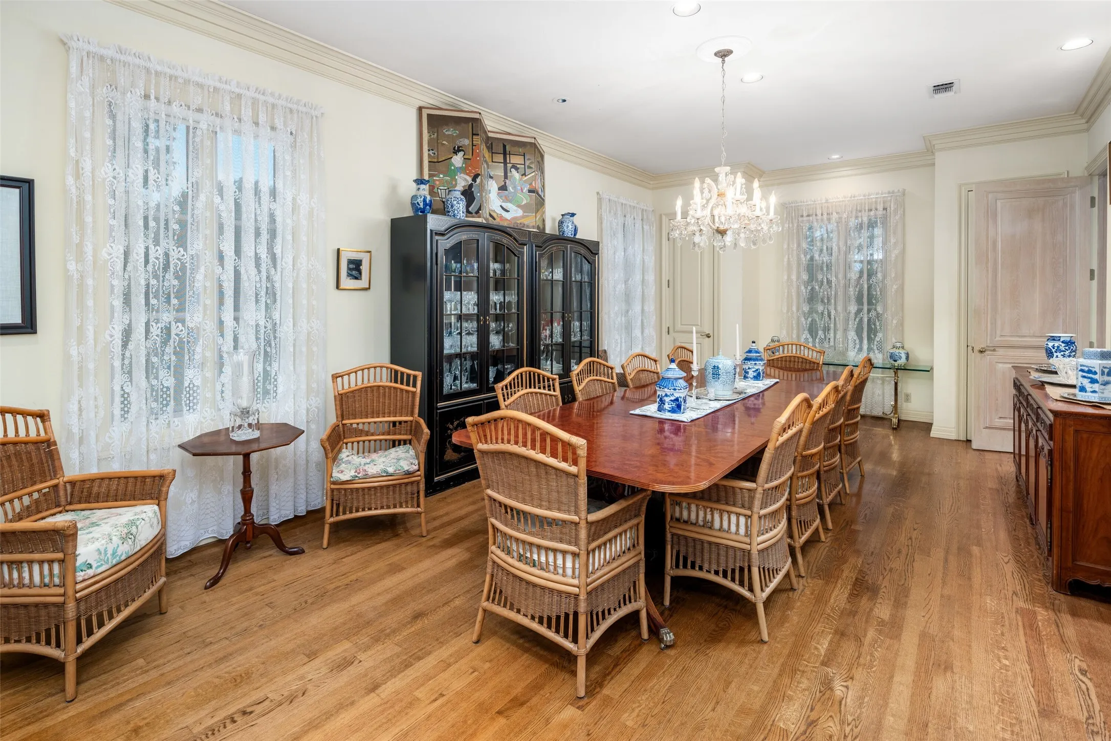 An oversized elegant dining room with a beautiful crystal chandelier located on the third level.
