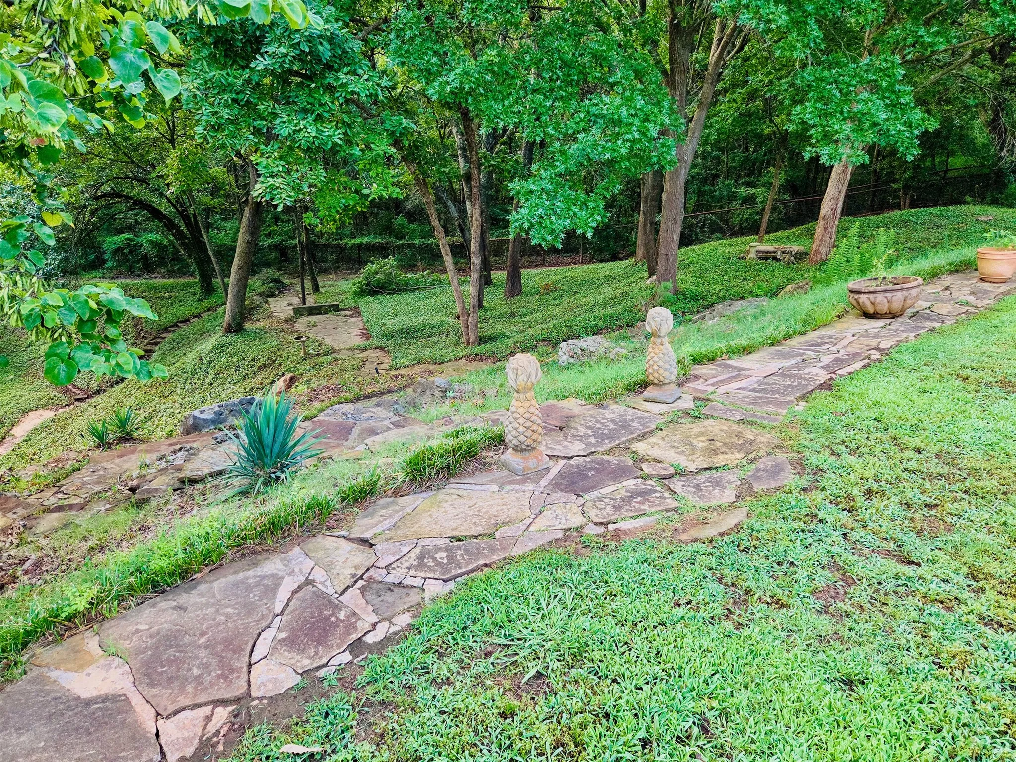 View of the private walking path that leads down to a white sand beach on the lake.