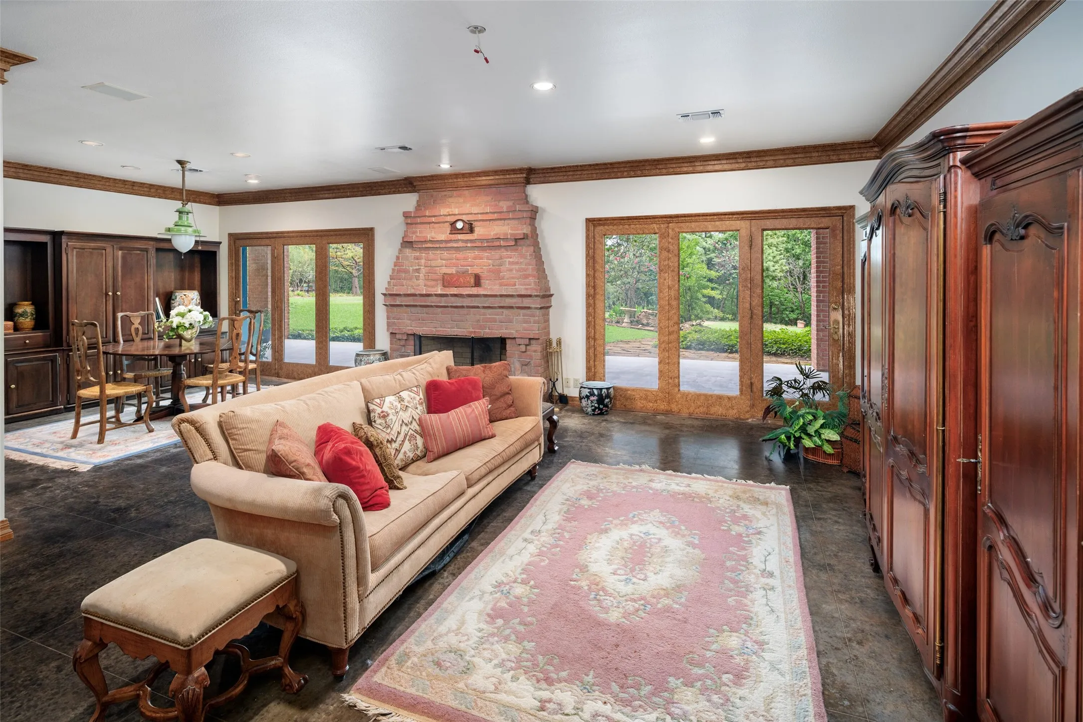 Living room located on the first ground level with a wood burning fireplace, dining area, kitchen and private covered patio.