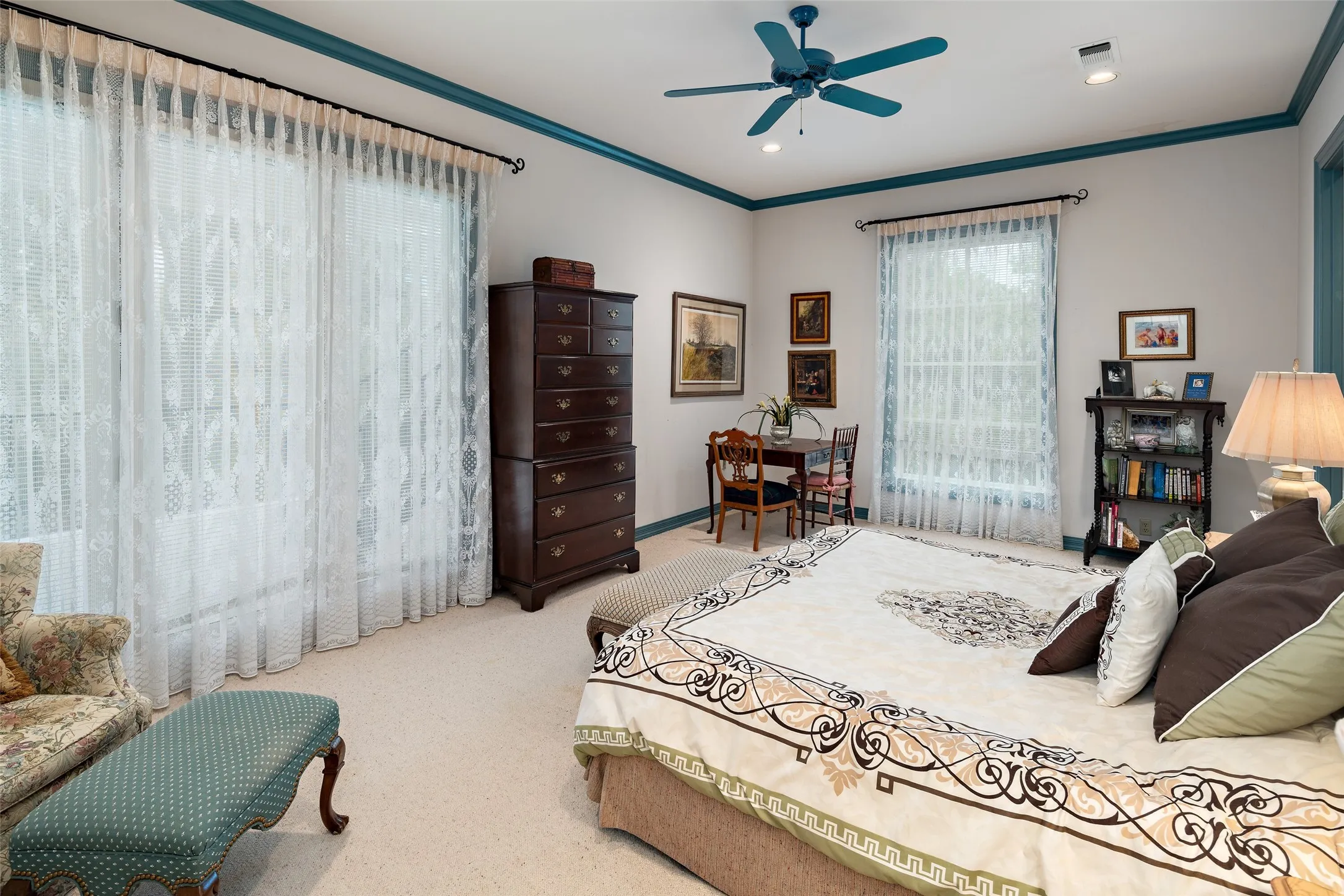 Oversized guest bedroom with private balcony and an attached ensuite bath located on the second level.