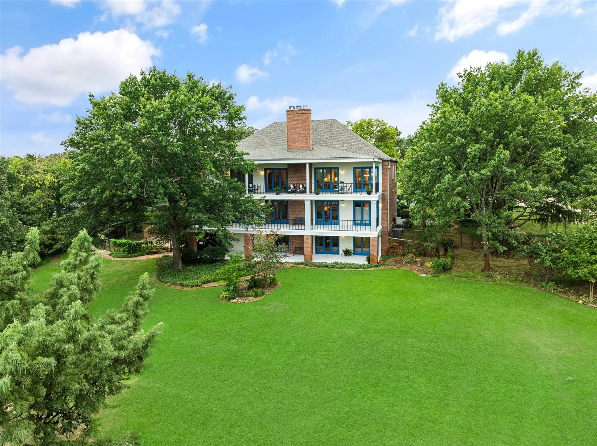 Stunning view of the back of house and landscaping.