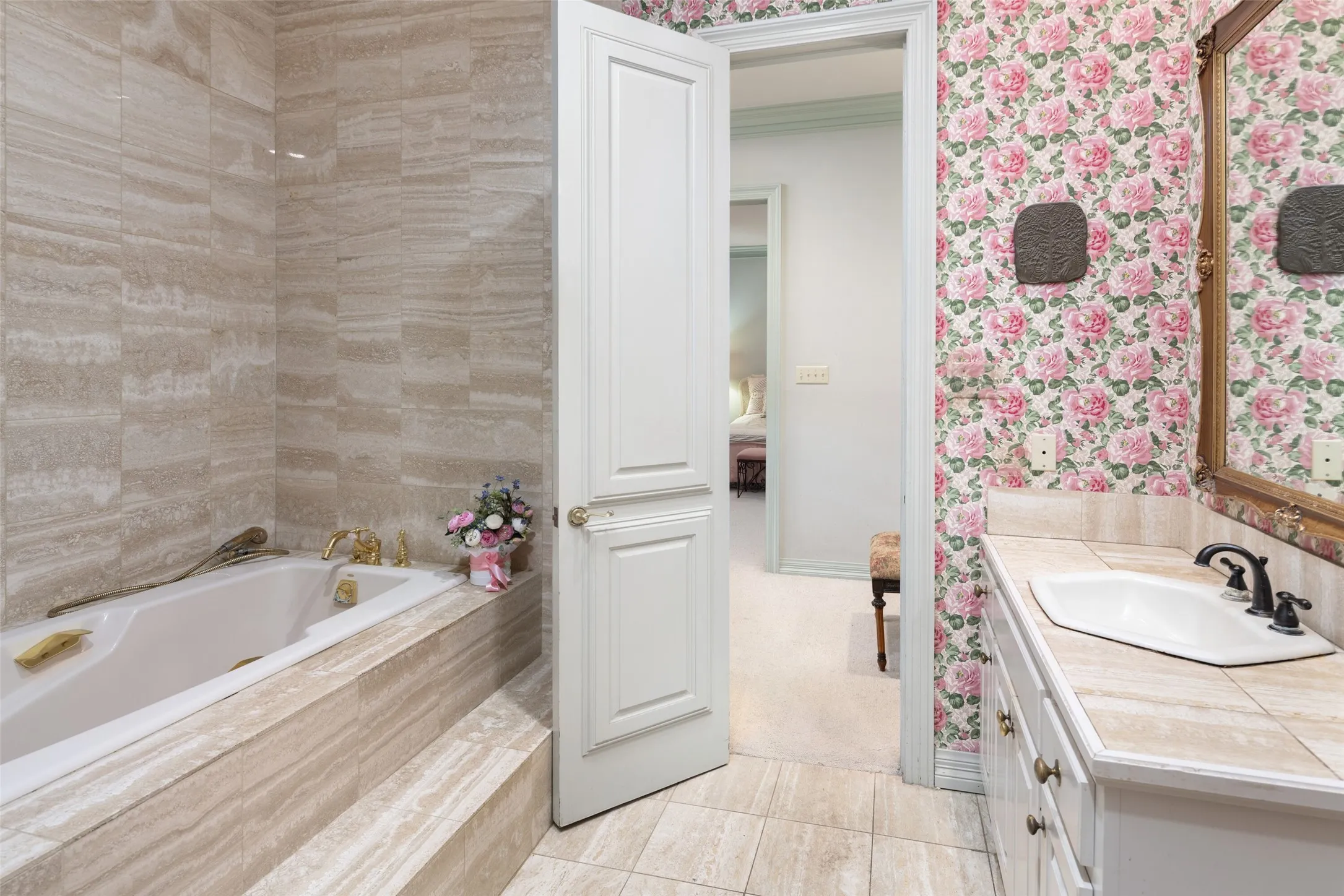 Separate bathroom with oversized walk in closets and soaking tub surrounded by marble.