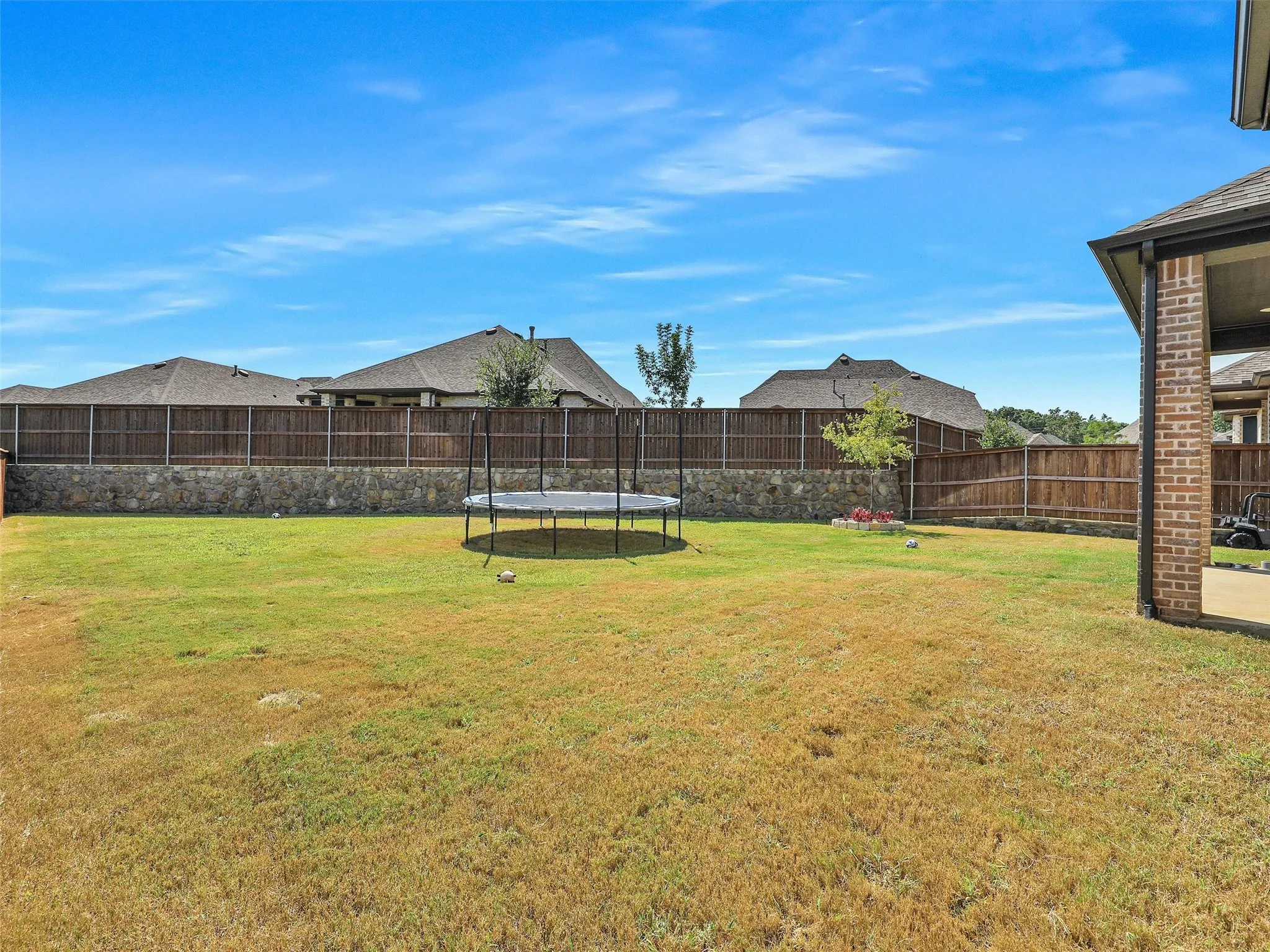 Situated on a quarter acre lot and completely fenced, this backyard allows space for outdoor dining, a kitchen area, pool, play area, gardening... all of it!