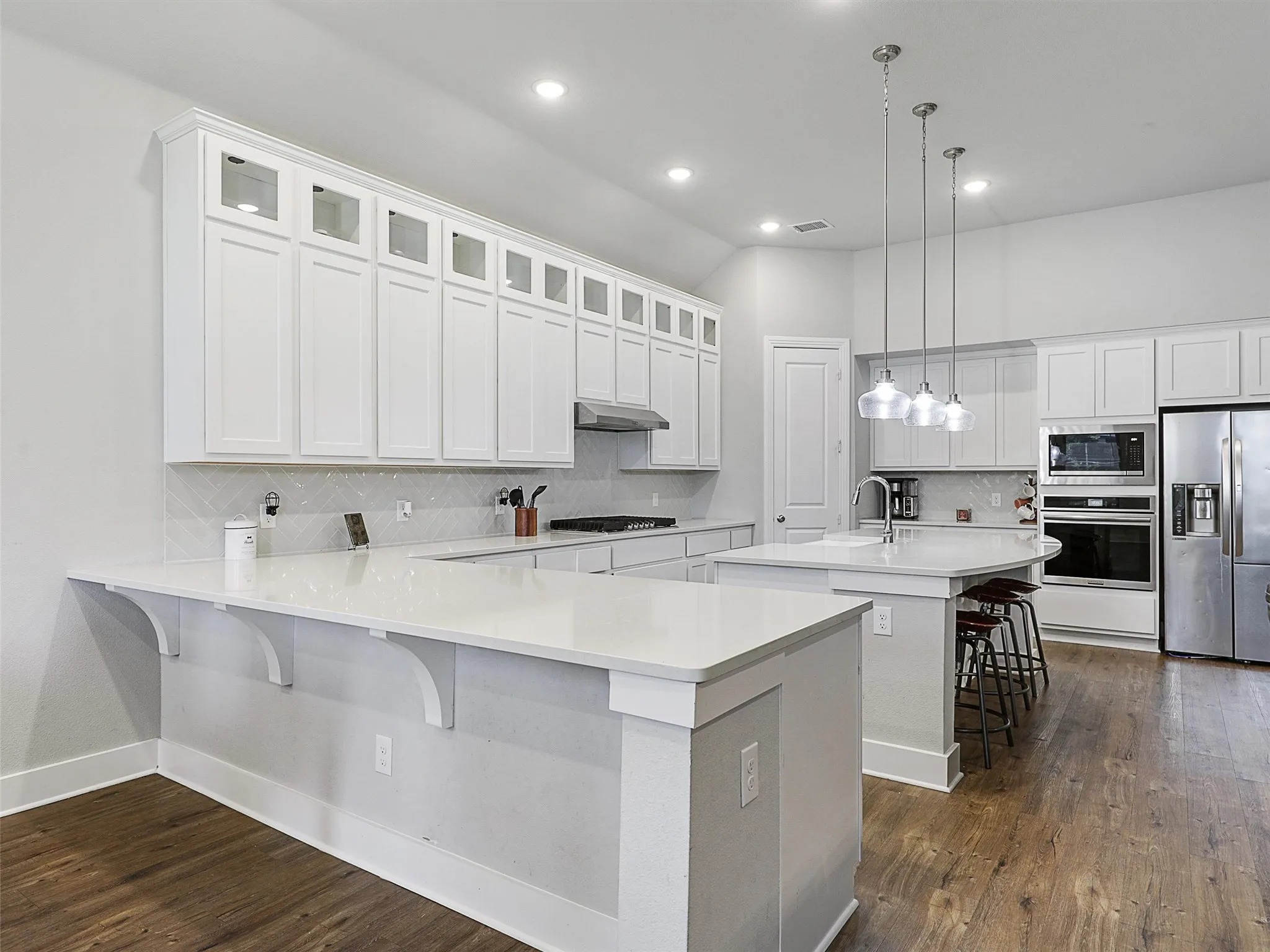 Enjoy casual meals or family dinners in the light-filled dining space, ideally located just off the kitchen with ample room for a full-size table and buffet, alongside this expansive bar area, where even MORE seating is available.