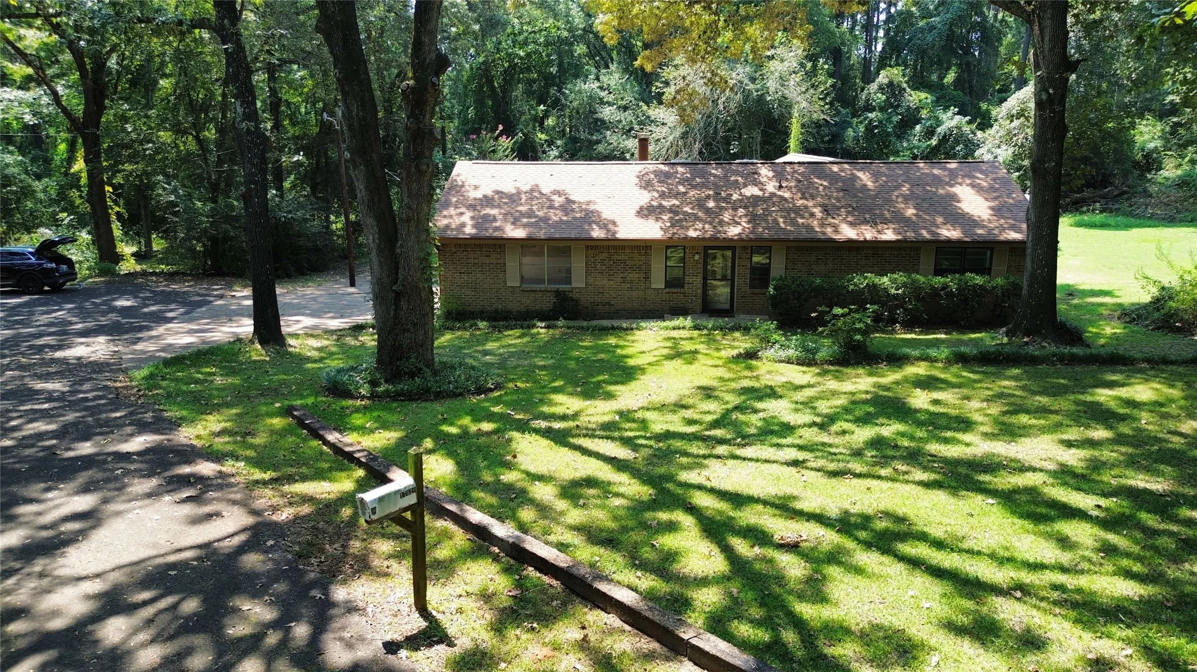 Single story home with a front lawn and brick siding