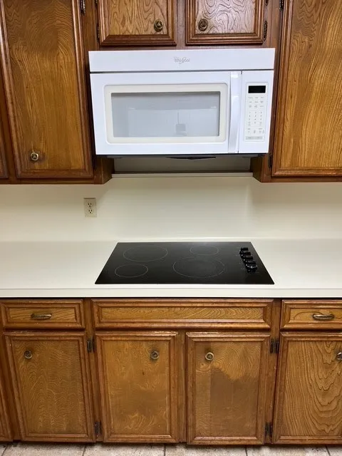 Kitchen with black appliances and brown cabinets