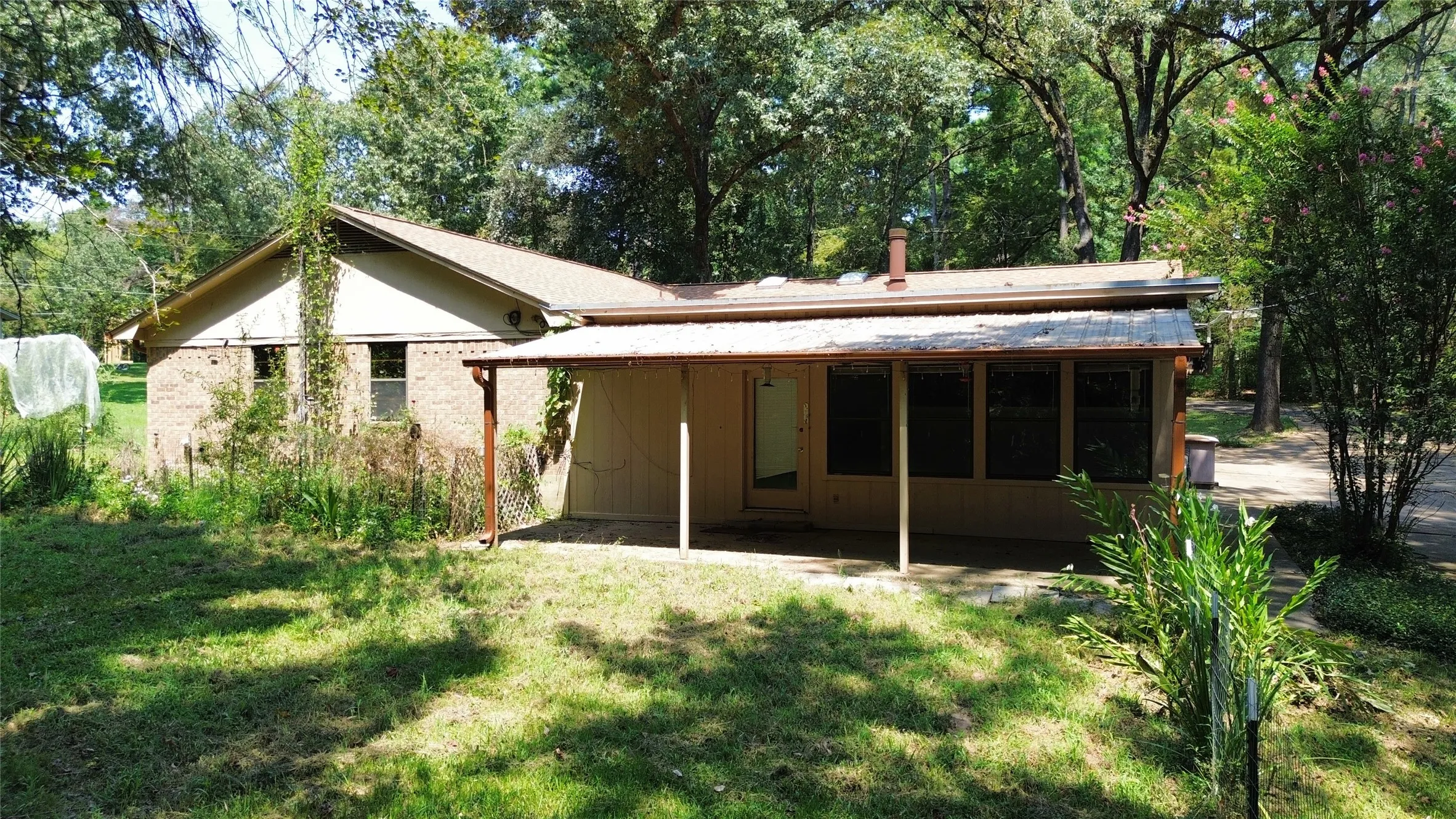 Rear view of property featuring a yard and a patio area