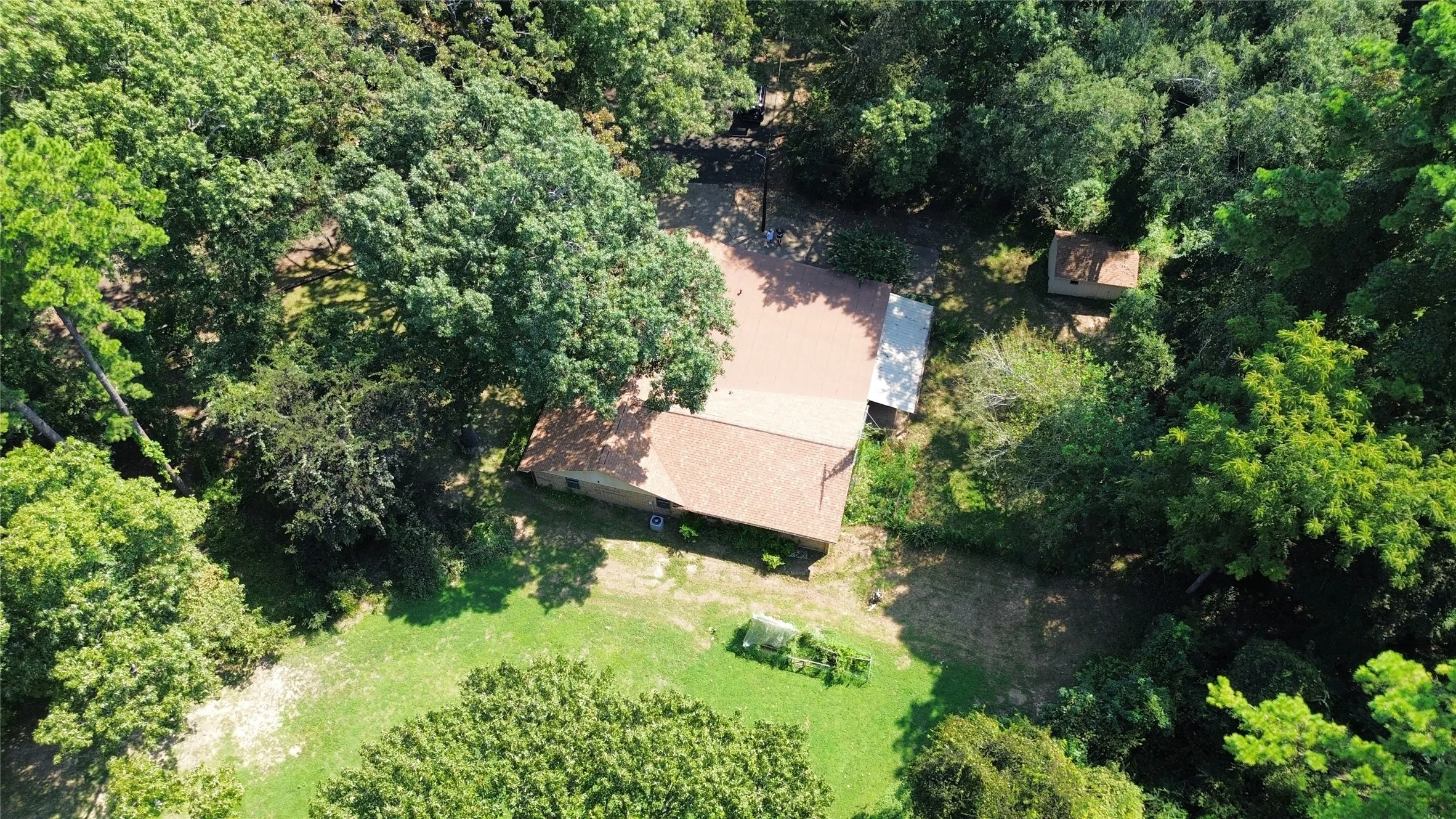 View of property location with a heavily wooded area