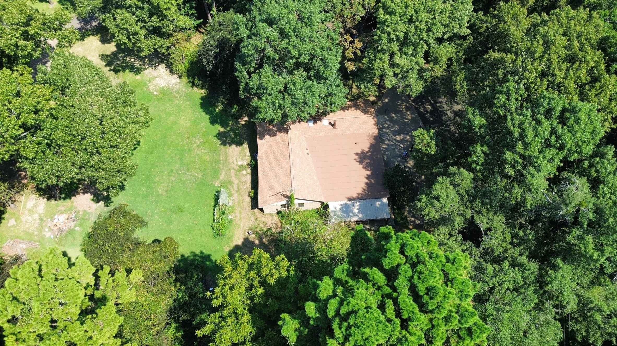View of subject property featuring a forest