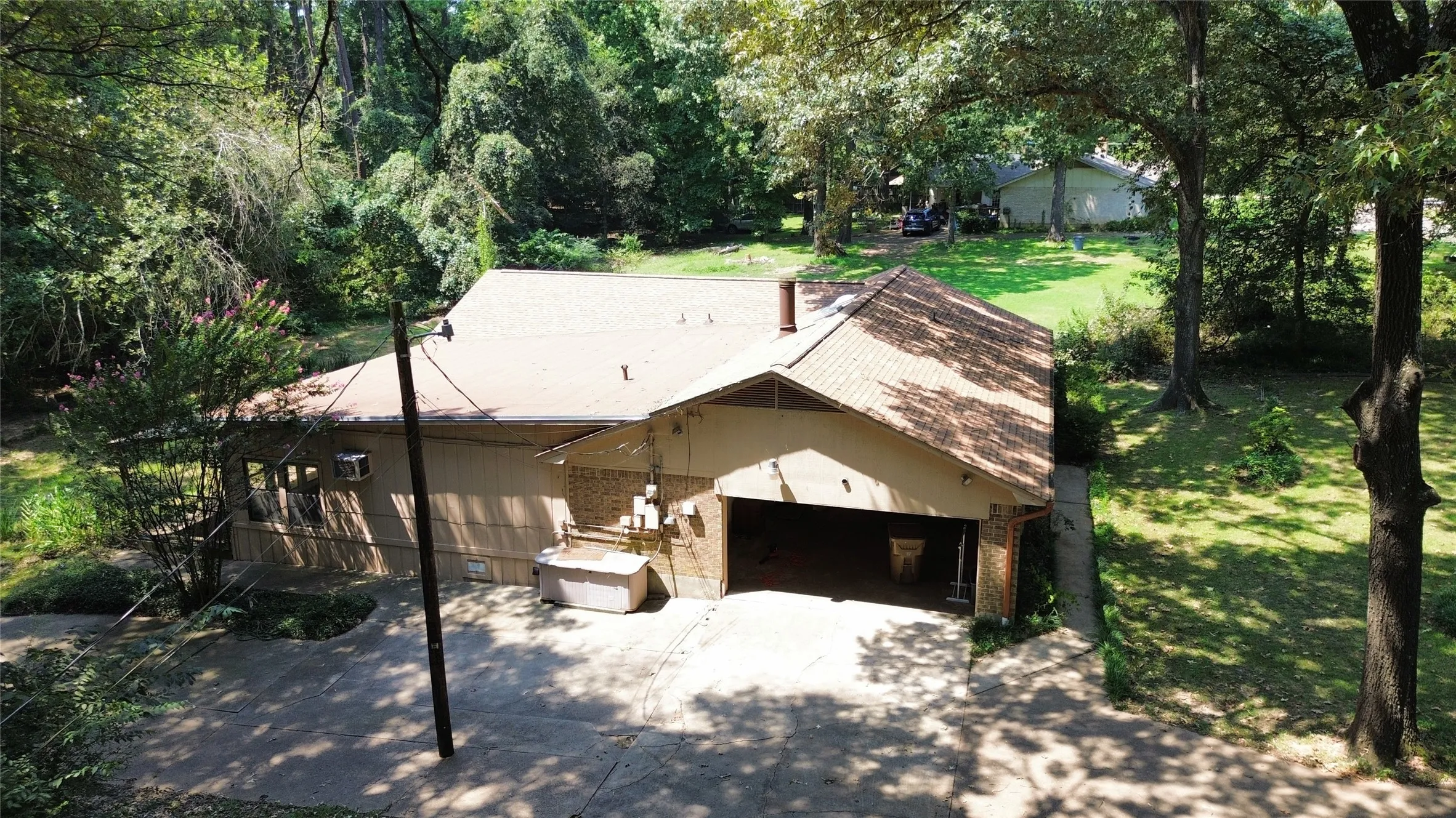 View of front of property featuring a garage, a front lawn, driveway, and brick siding