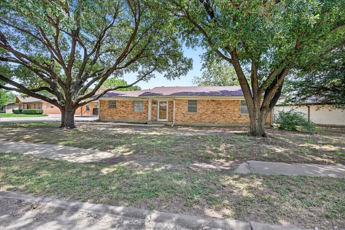 Ranch-style house featuring brick siding