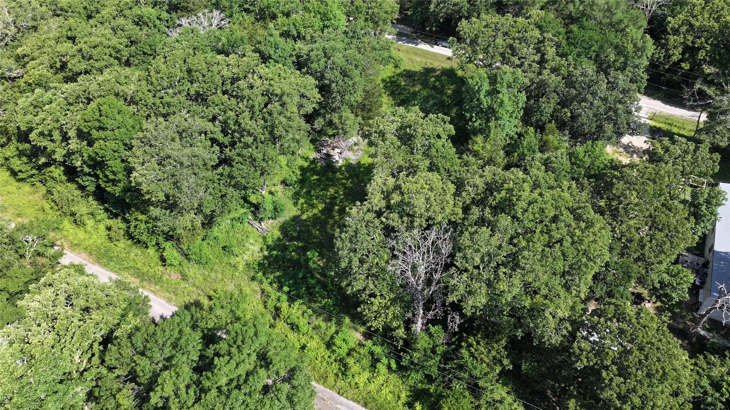 Aerial overview of property's location featuring a heavily wooded area
