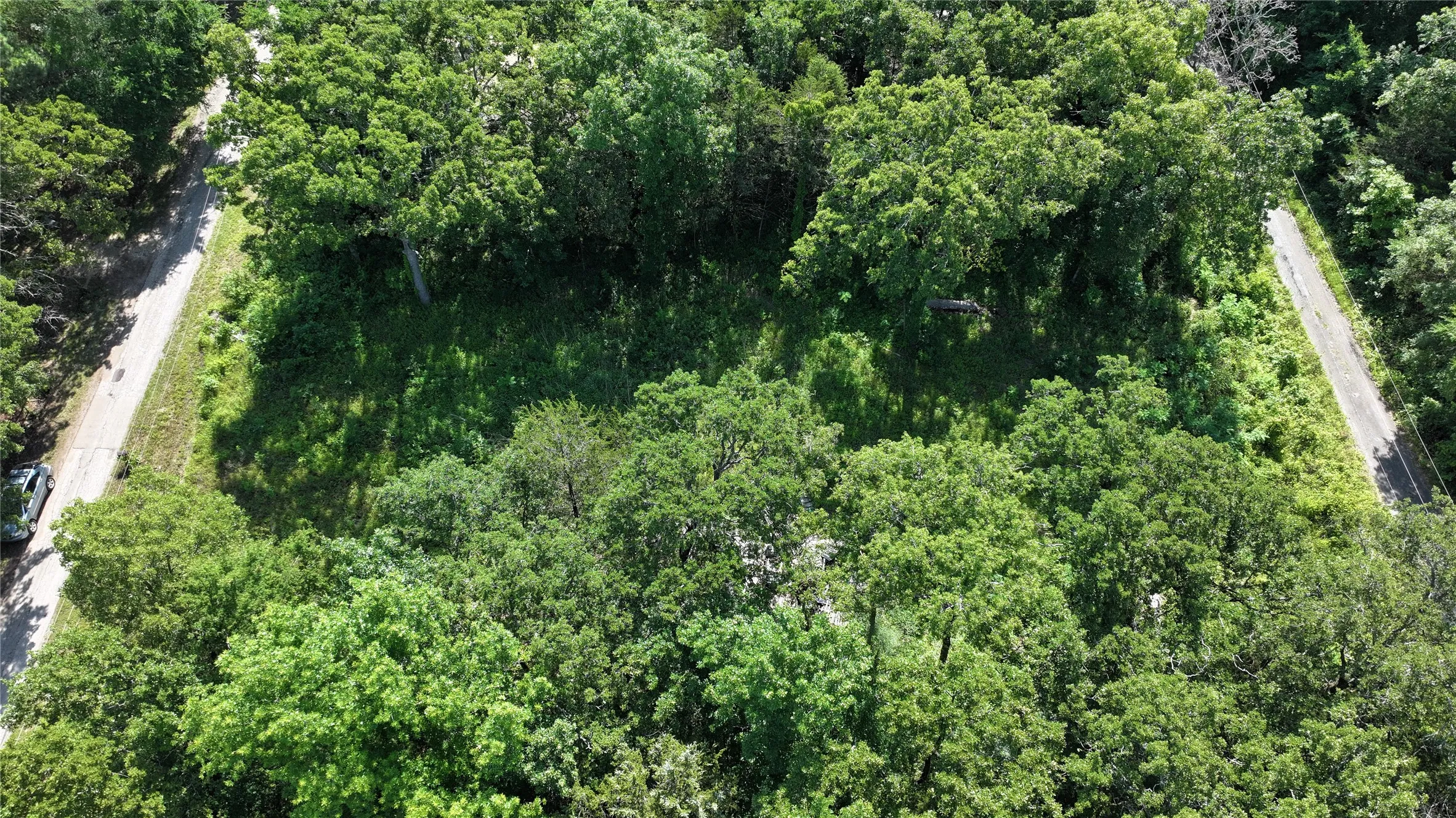 View of property location featuring a heavily wooded area