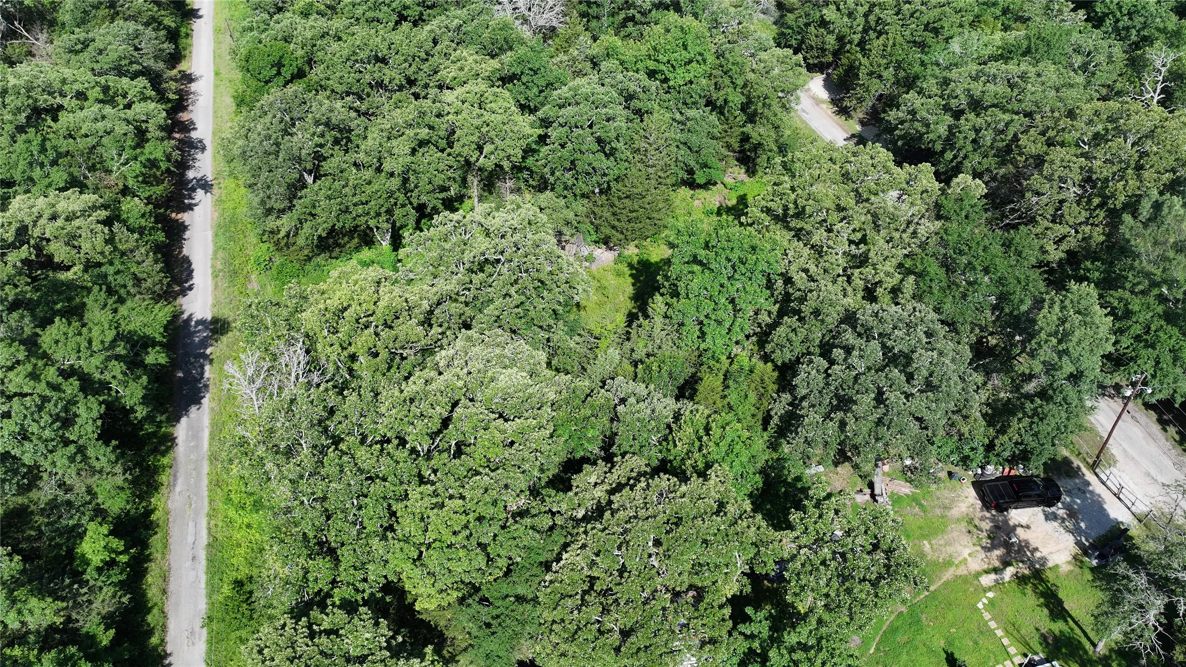 Aerial overview of property's location featuring a heavily wooded area