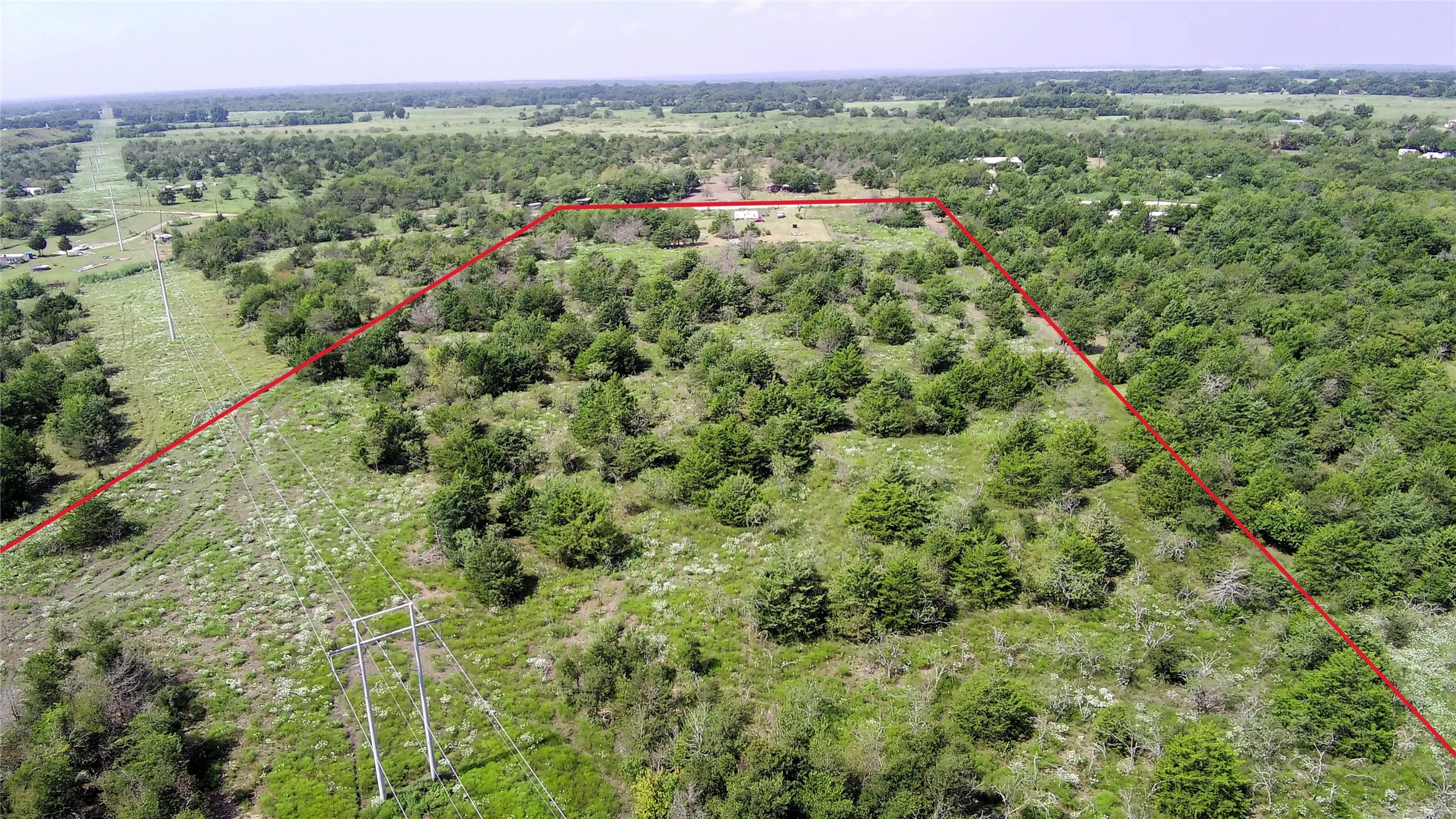 Aerial view of property and surrounding area featuring property boundaries highlighted