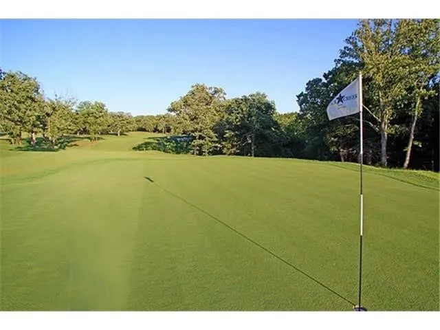 View of community featuring view of golf course and view of wooded area